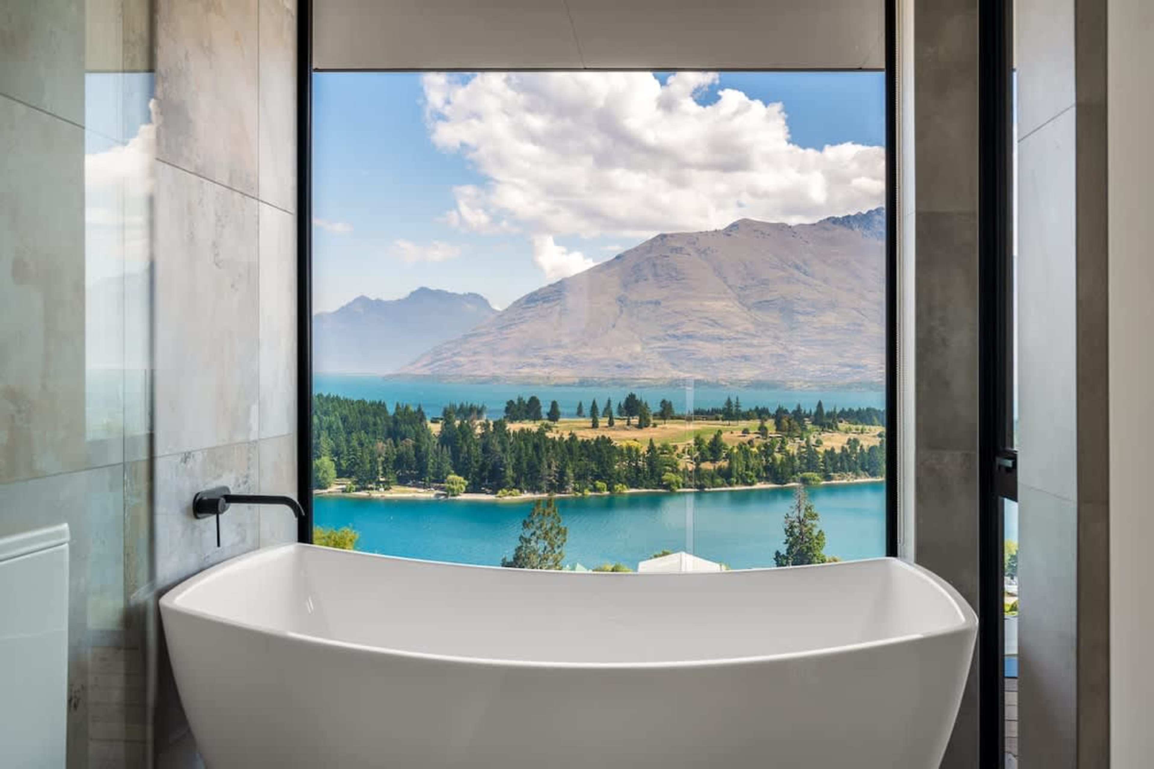 Spa-like Master Ensuite with Heated Floors and Bathtub Views
Indulge in the master ensuite’s heated floors and bathtub, where you can relax while soaking in breathtaking views of the lake, all while enjoying Ashley & Co toiletries.