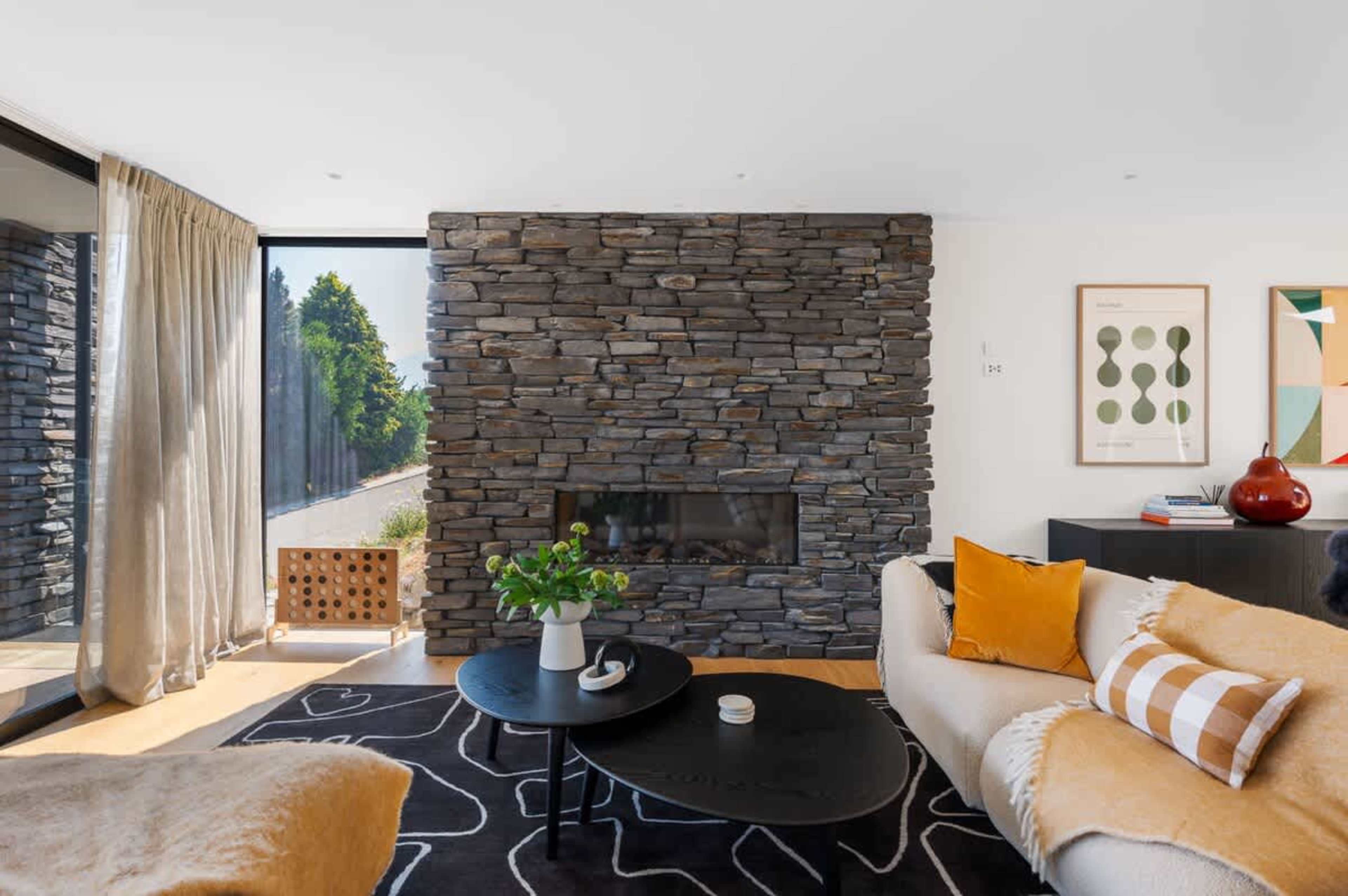 Bright Living Room with Panoramic Lake Views
The living room is bathed in natural light, offering stunning, uninterrupted views of Lake Wakatipu and the surrounding mountains.