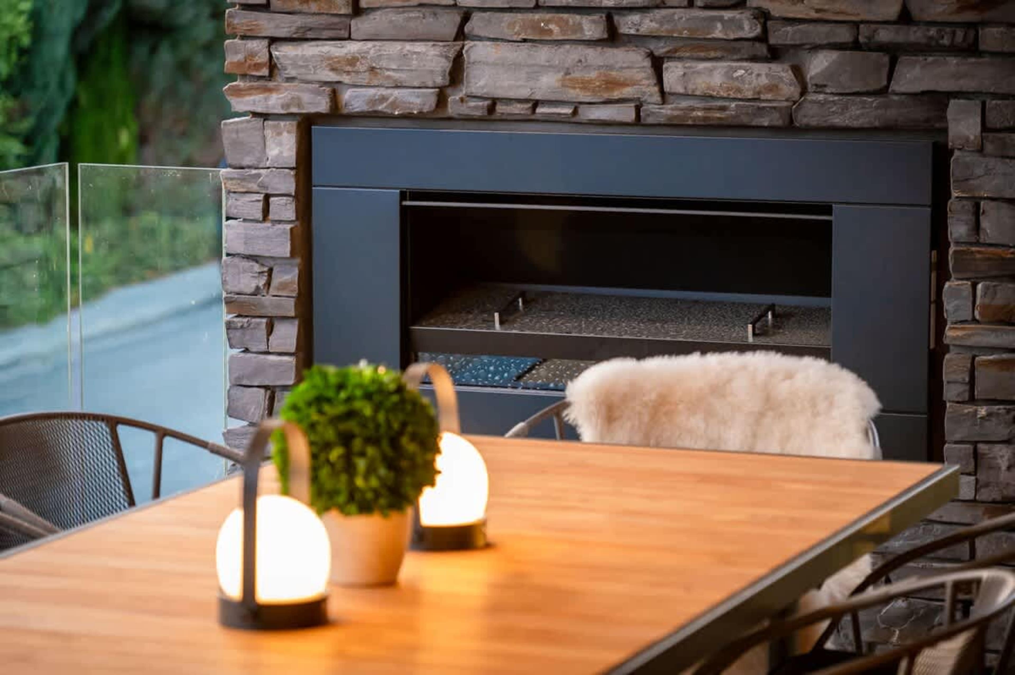 Scenic Outdoor Dining Area with Gas Fireplace
Enjoy meals on the outdoor dining table while taking in breathtaking lake and mountain views, with the comfort of a gas fireplace to enhance your experience.