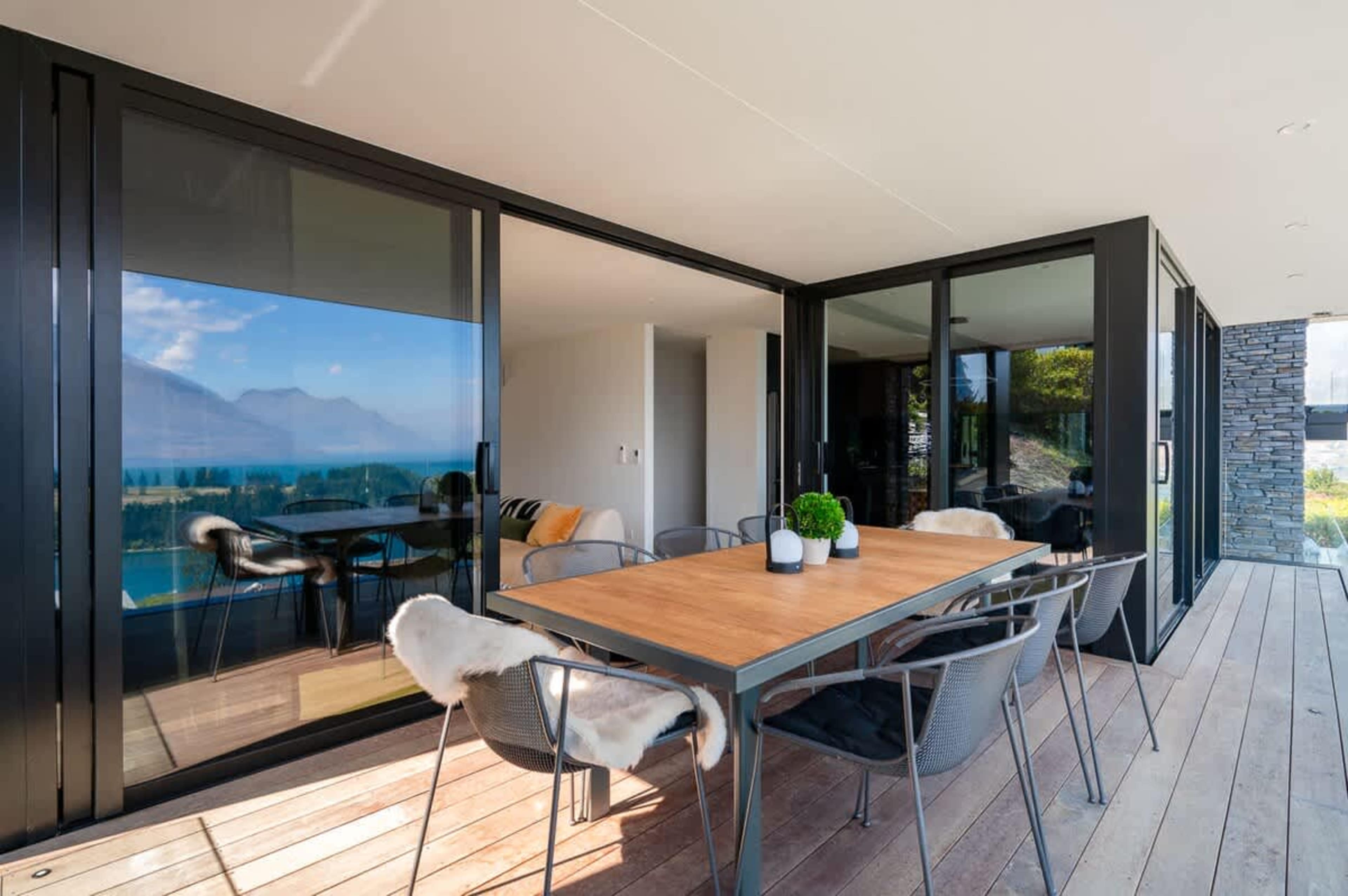 Outdoor Dining with Lake Views and Gas Fireplace
Dine al fresco at the outdoor table, surrounded by stunning lake views and a cozy gas fireplace for added warmth and ambiance.
