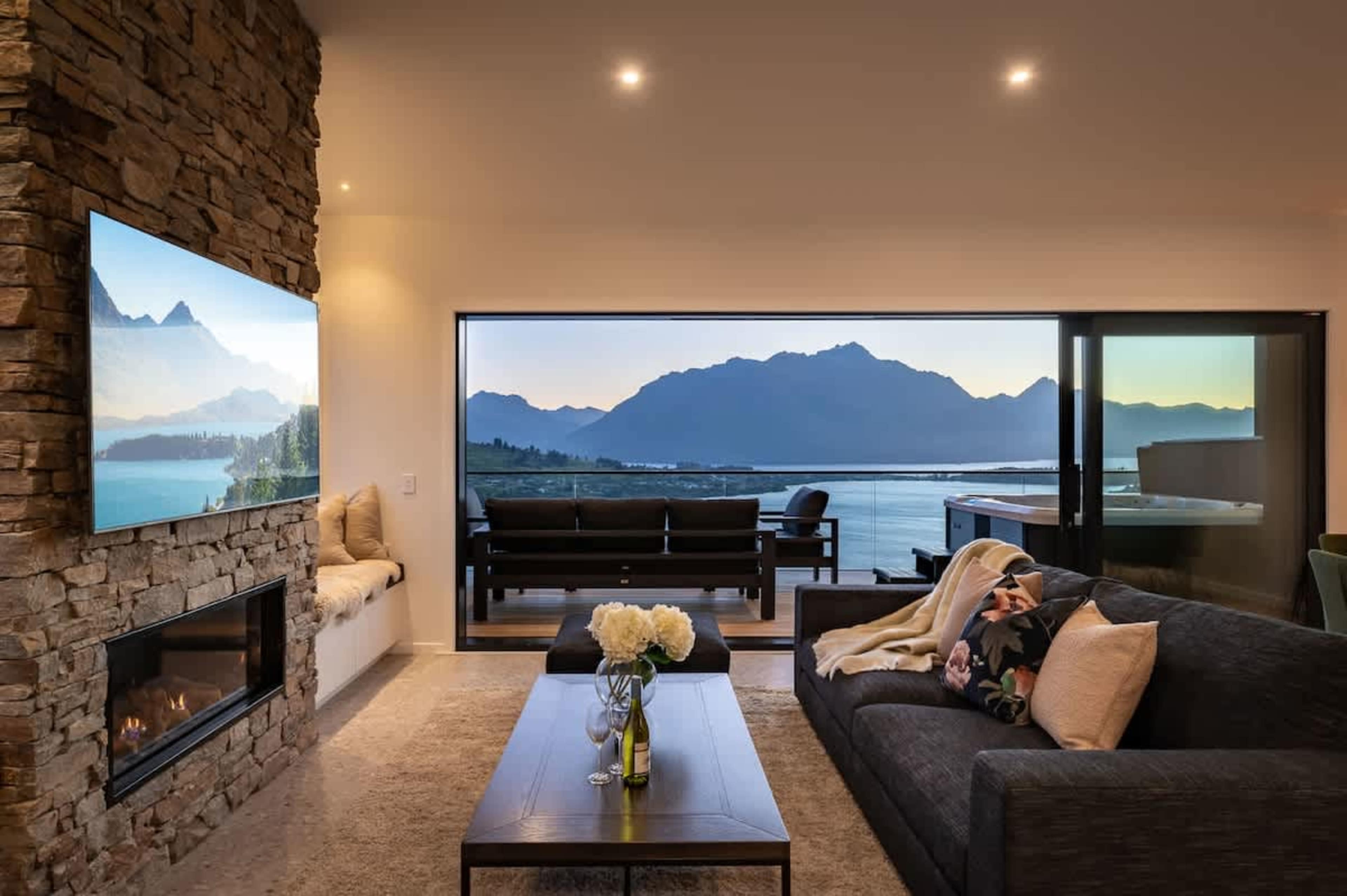 The expansive windows frame the breathtaking scenery, creating a perfect balance of comfort and natural beauty. 