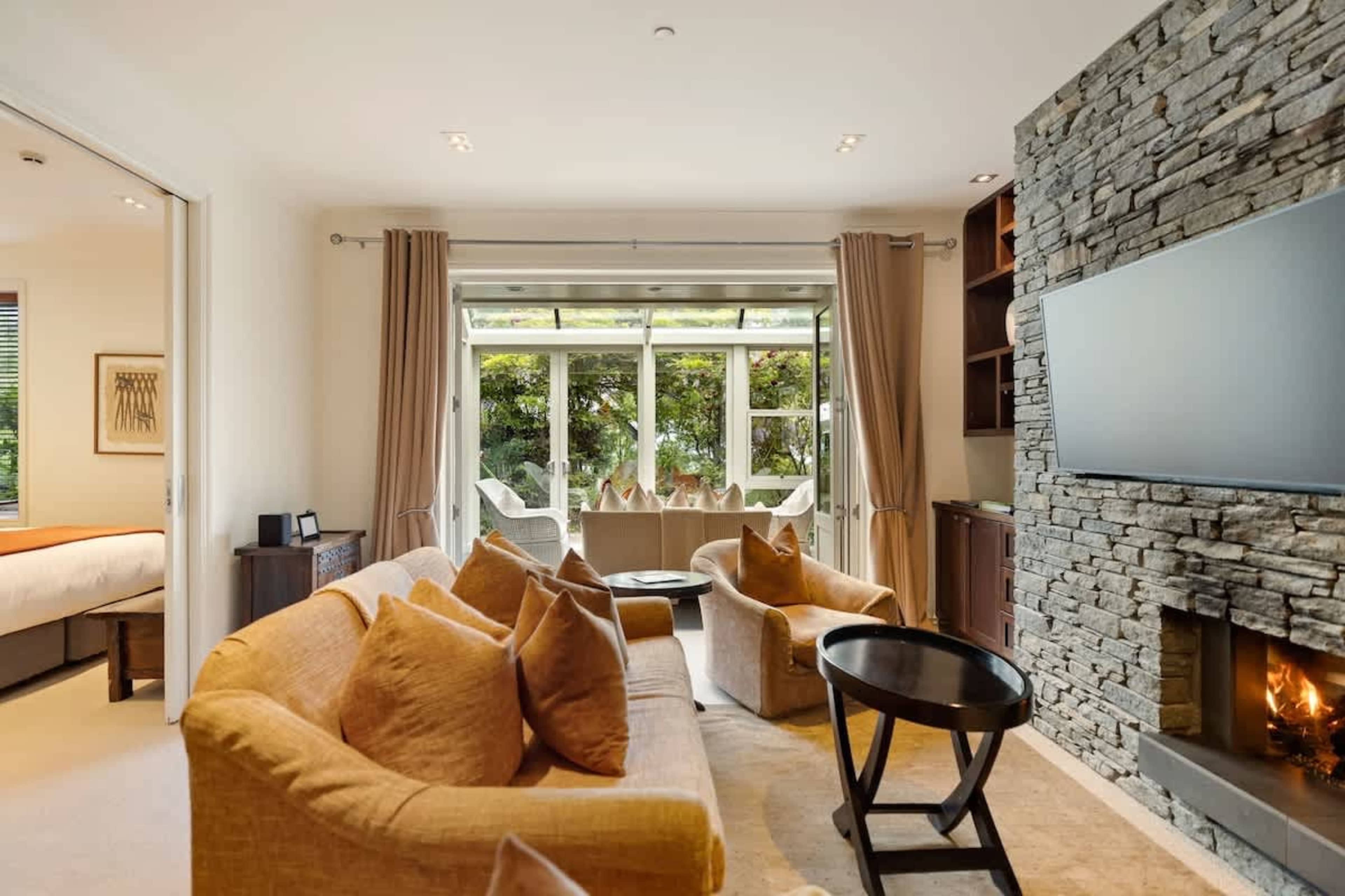 Luxury Living with a Stunning Conservatory – Relax in this stylish lounge, featuring plush seating, a gas fireplace, air-conditioning, and a sun-drenched conservatory for year-round comfort.