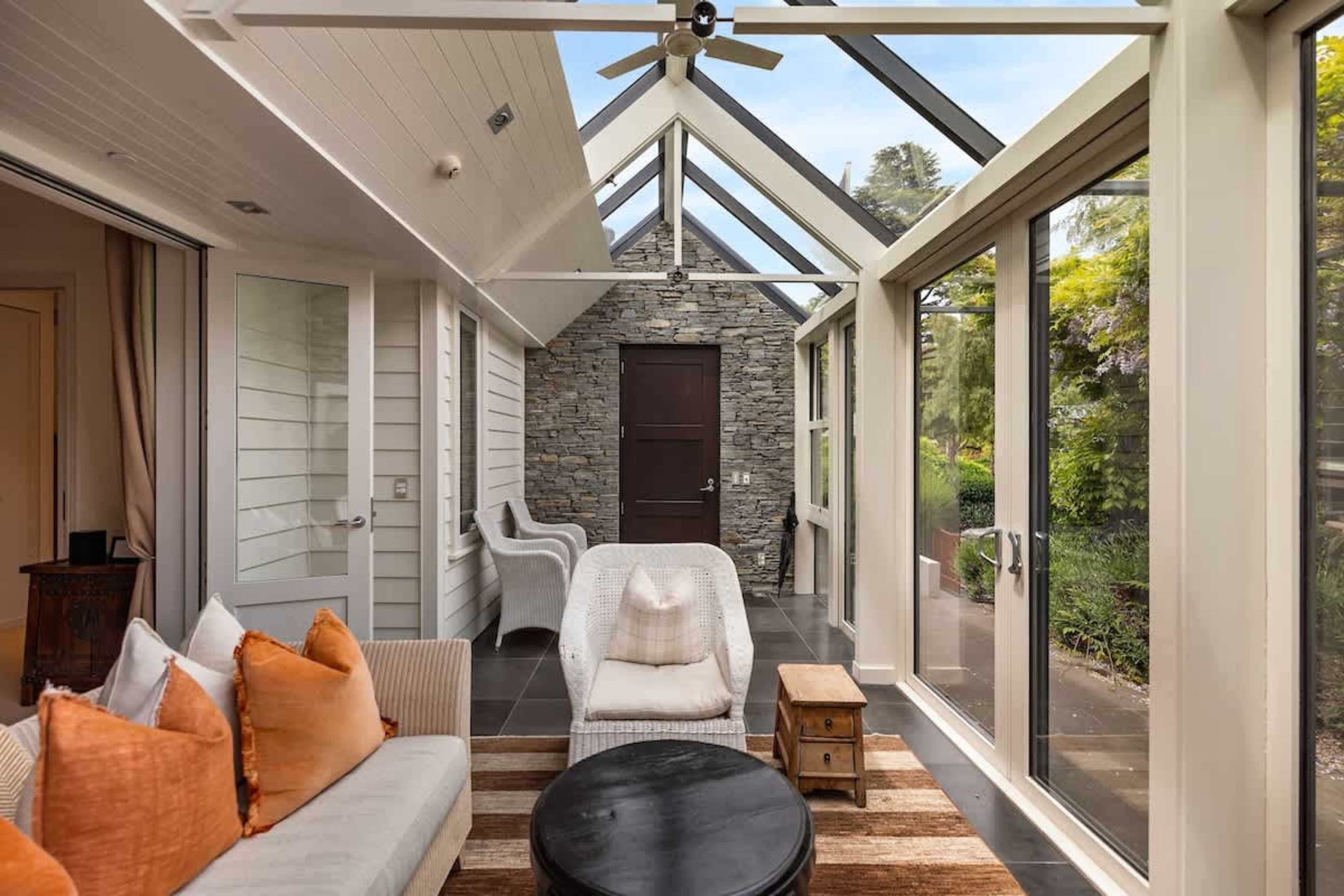 Unwind with Queenstown’s Best Views – The conservatory offers a serene space to relax, with floor-to-ceiling windows showcasing the breathtaking lakefront scenery.