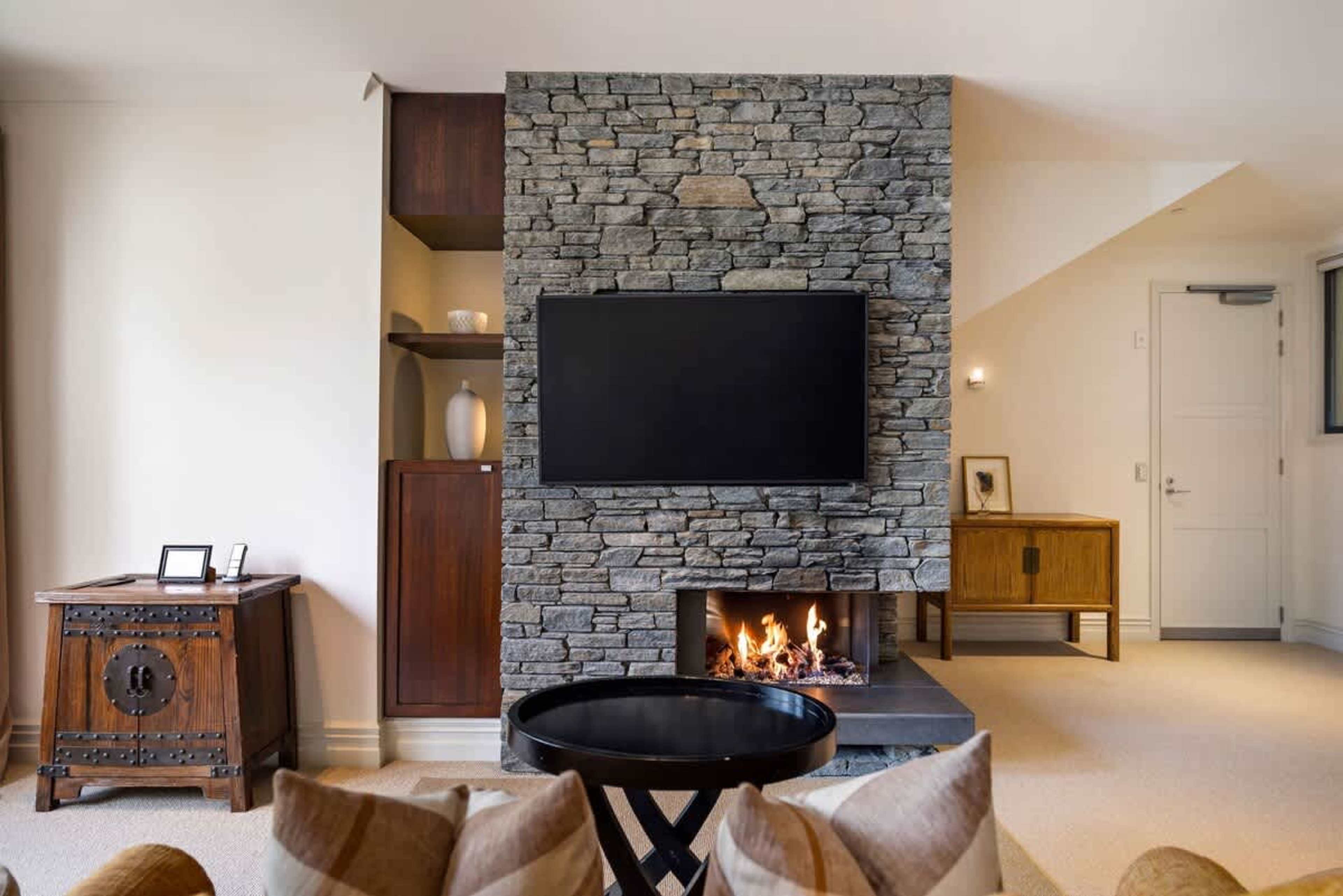 Cozy Living Space with a View – This spacious living area offers a gas fire for added warmth and air-conditioning for year-round comfort. Open the doors to your patio for an immersive outdoor experience.