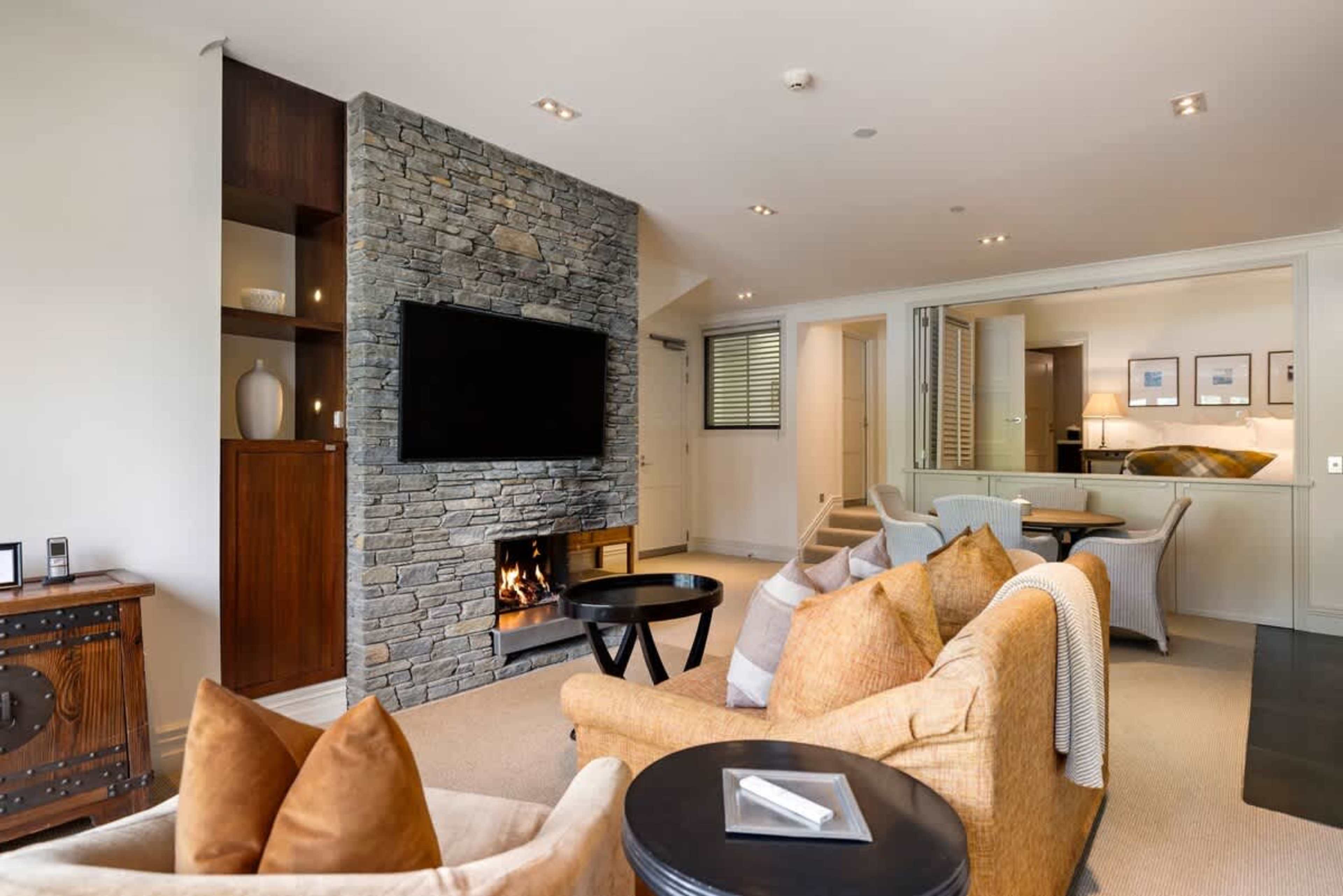 Stylish & Inviting Living Area – Kick back in this elegant lounge, complete with a gas fire, air-conditioning, and access to your patio where you can enjoy the outdoor beauty of Queenstown.