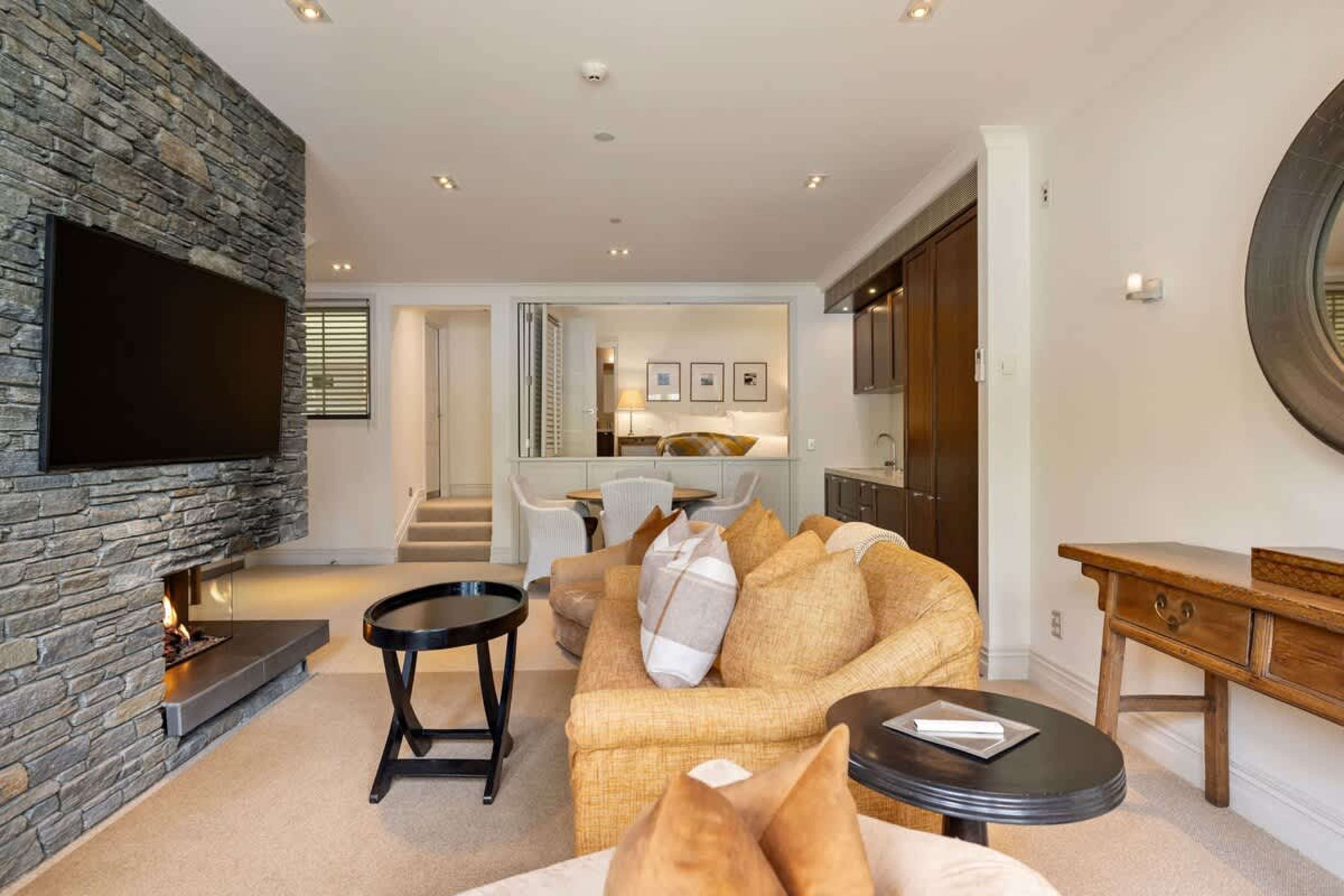 Modern & Inviting Living Space – Relax in comfort with air-conditioning, a gas fireplace, and contemporary décor. Step out onto the private patio for a peaceful retreat with scenic mountain views.