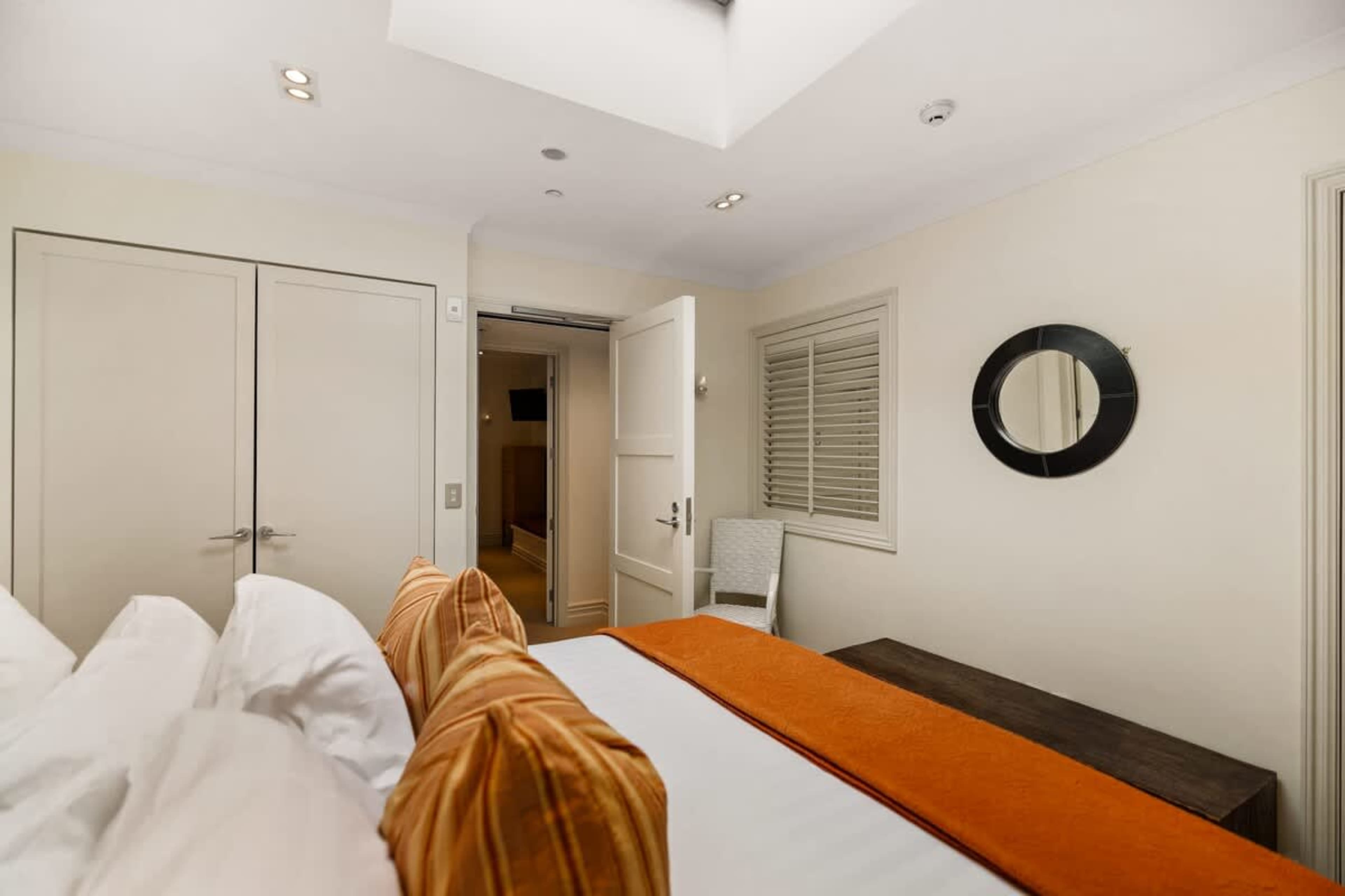 A Stylish Retreat with King Comfort – Unwind in the third bedroom, where a plush king bed, modern furnishings, and soft lighting ensure a restful and elegant stay.