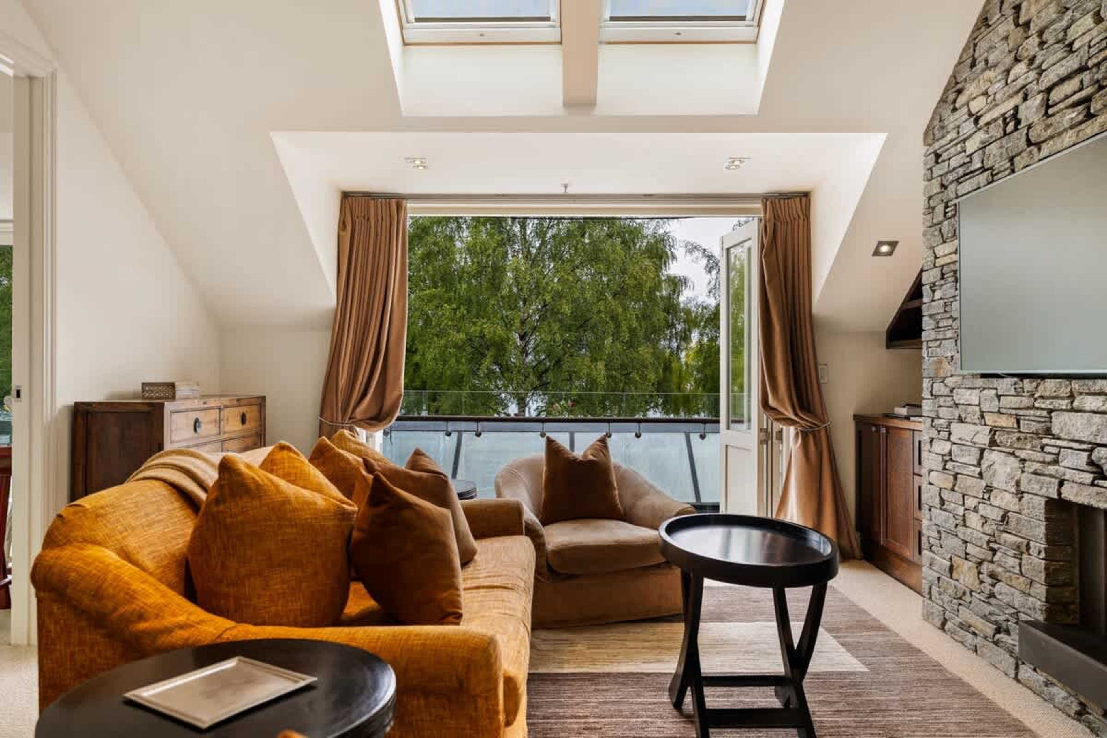 Spacious & Stylish Living Room – Relax in the elegant living space with plush seating, modern décor, and large windows offering natural light, creating the perfect spot to unwind in Queenstown.