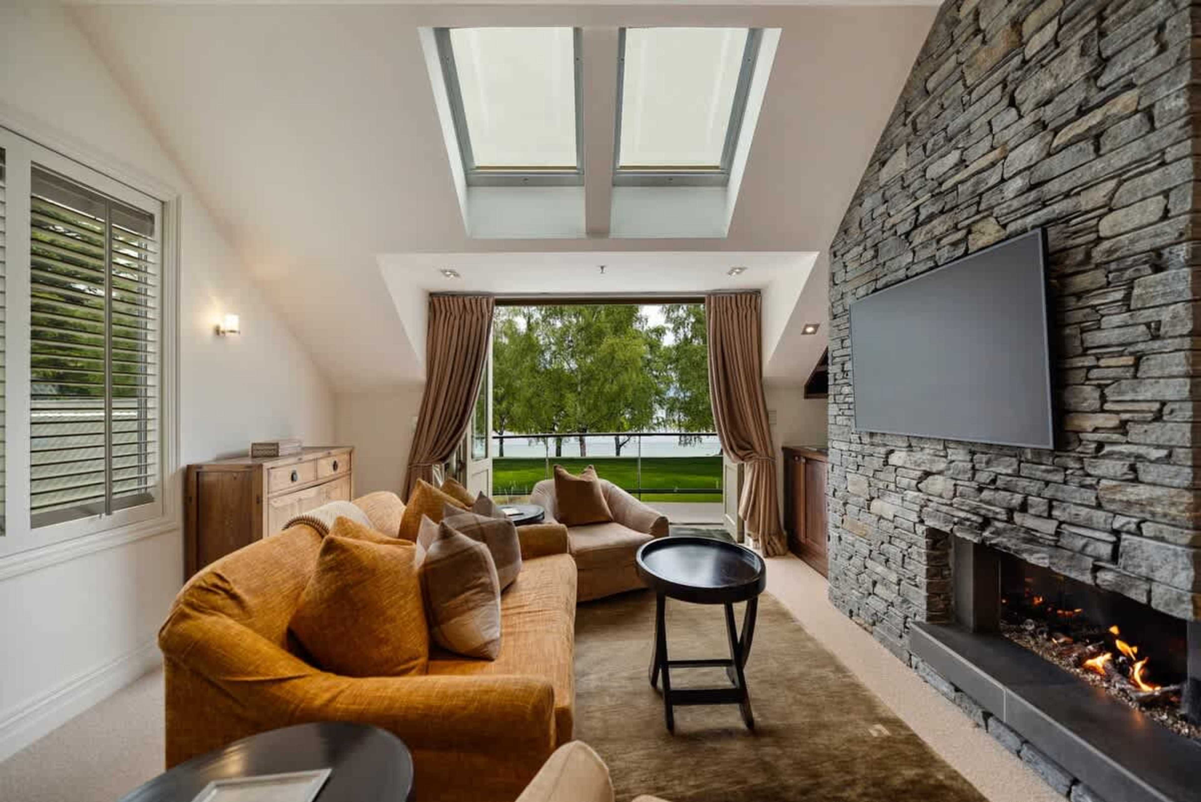 Luxury Living with a Balcony – This open-plan living space offers a stylish retreat, with a gas fireplace for cozy evenings and a balcony to enjoy breathtaking views.