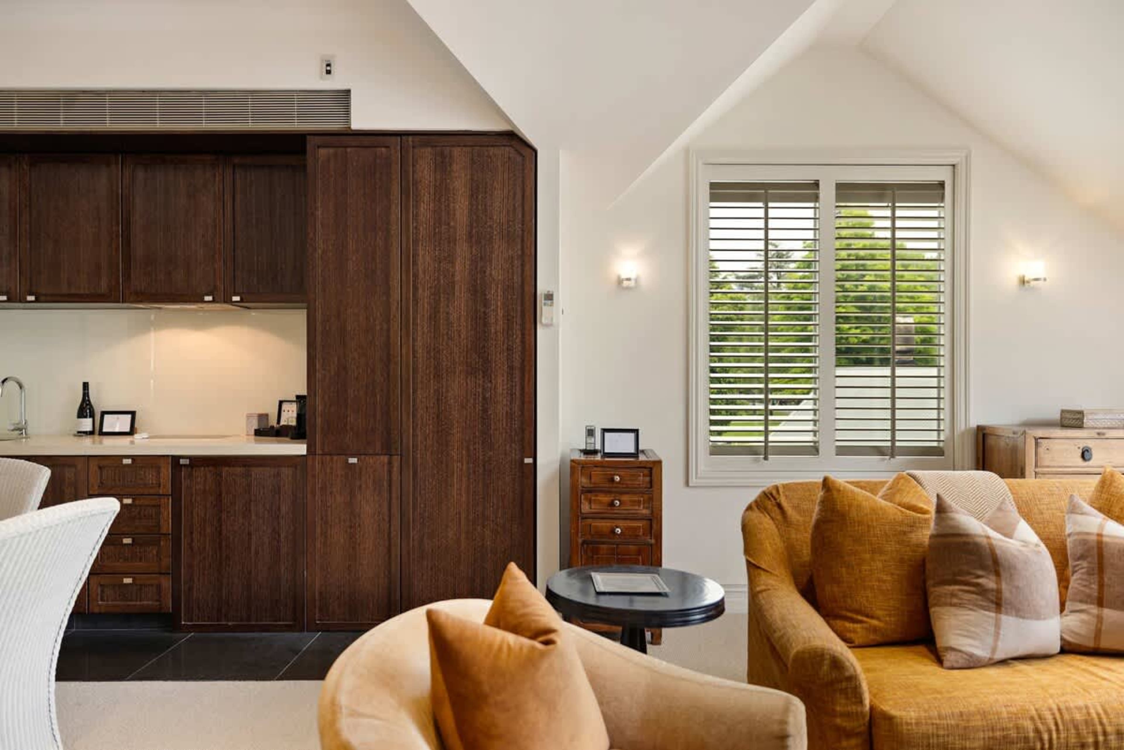 Luxury Meets Cozy Charm – Whether you're curling up by the gas fire in winter or enjoying the fresh alpine breeze through open balcony doors, this inviting living room is the perfect place to unwind.