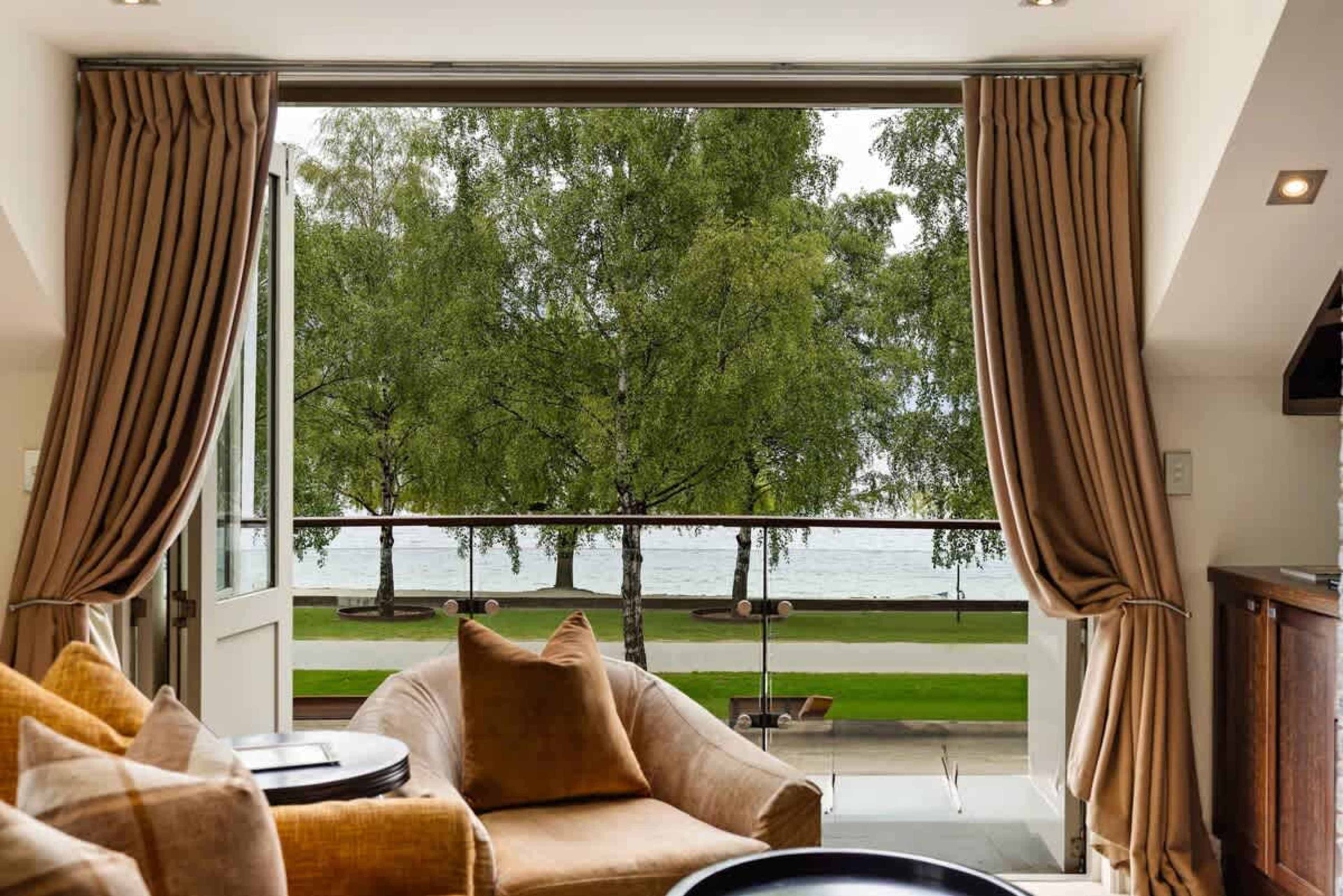 Bright & Airy with Stunning Scenery – The spacious lounge is bathed in natural light, leading to a private balcony where you can soak in lake and mountain views.