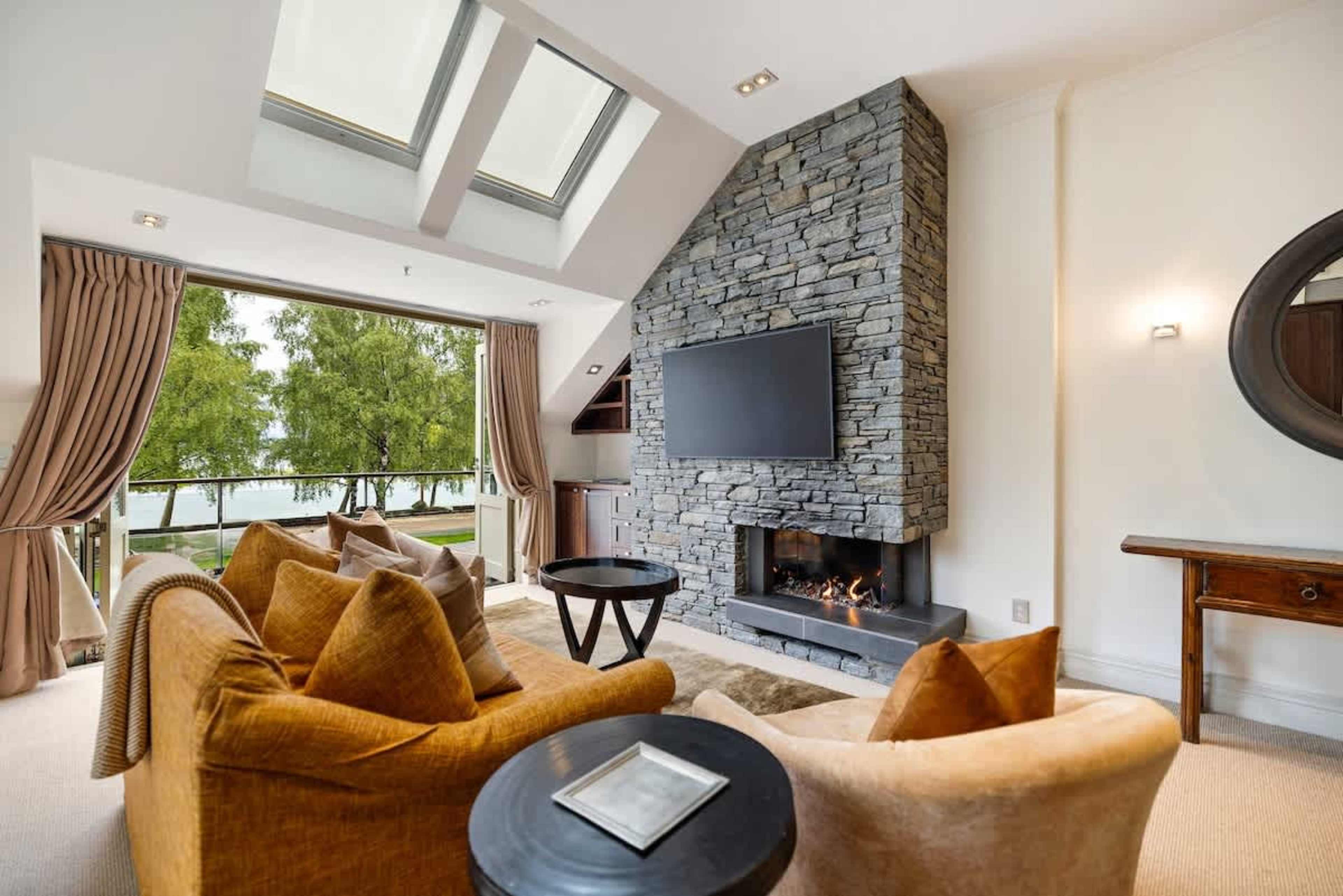 Luxury Living with a Balcony – This open-plan living space offers a stylish retreat, with a gas fireplace for cozy evenings and a balcony to enjoy breathtaking views.