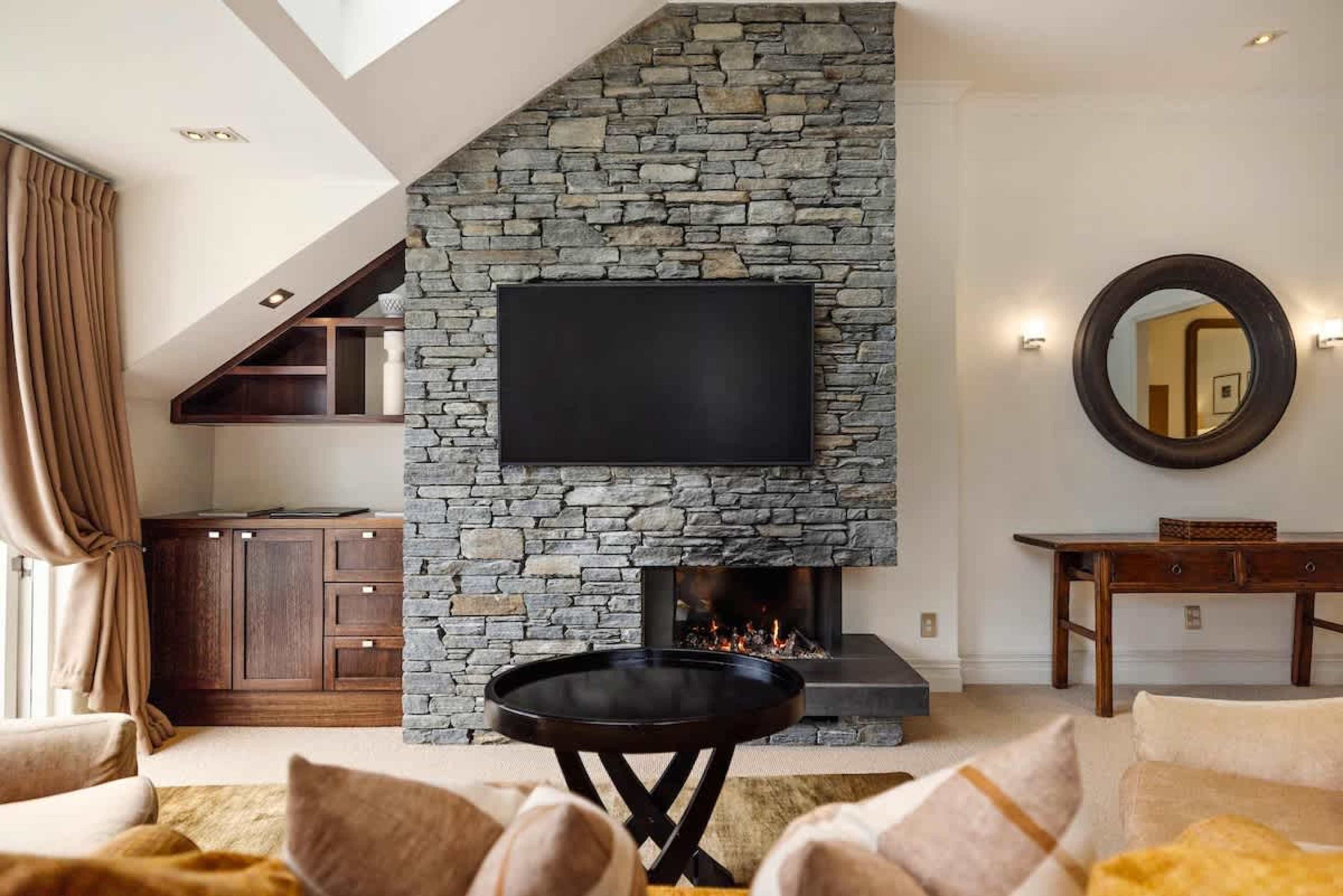 Perfect Space for Relaxation – Whether you’re lounging by the gas fire or stepping onto your balcony for fresh mountain air, this living room offers ultimate comfort and style.