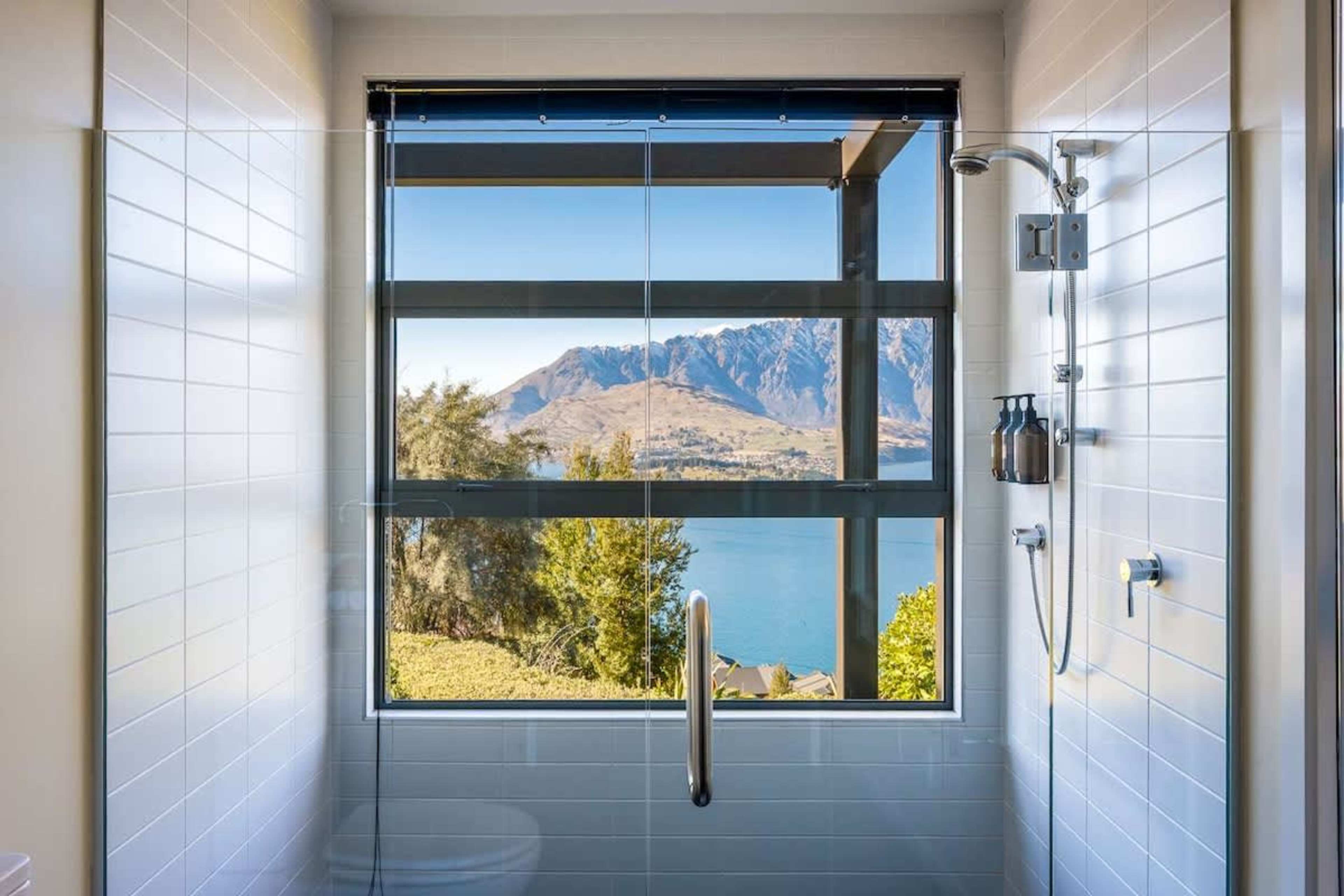 The second ensuite features a sleek, modern design with a spacious shower and high-quality fixtures. It offers privacy and comfort for your Queenstown stay.
