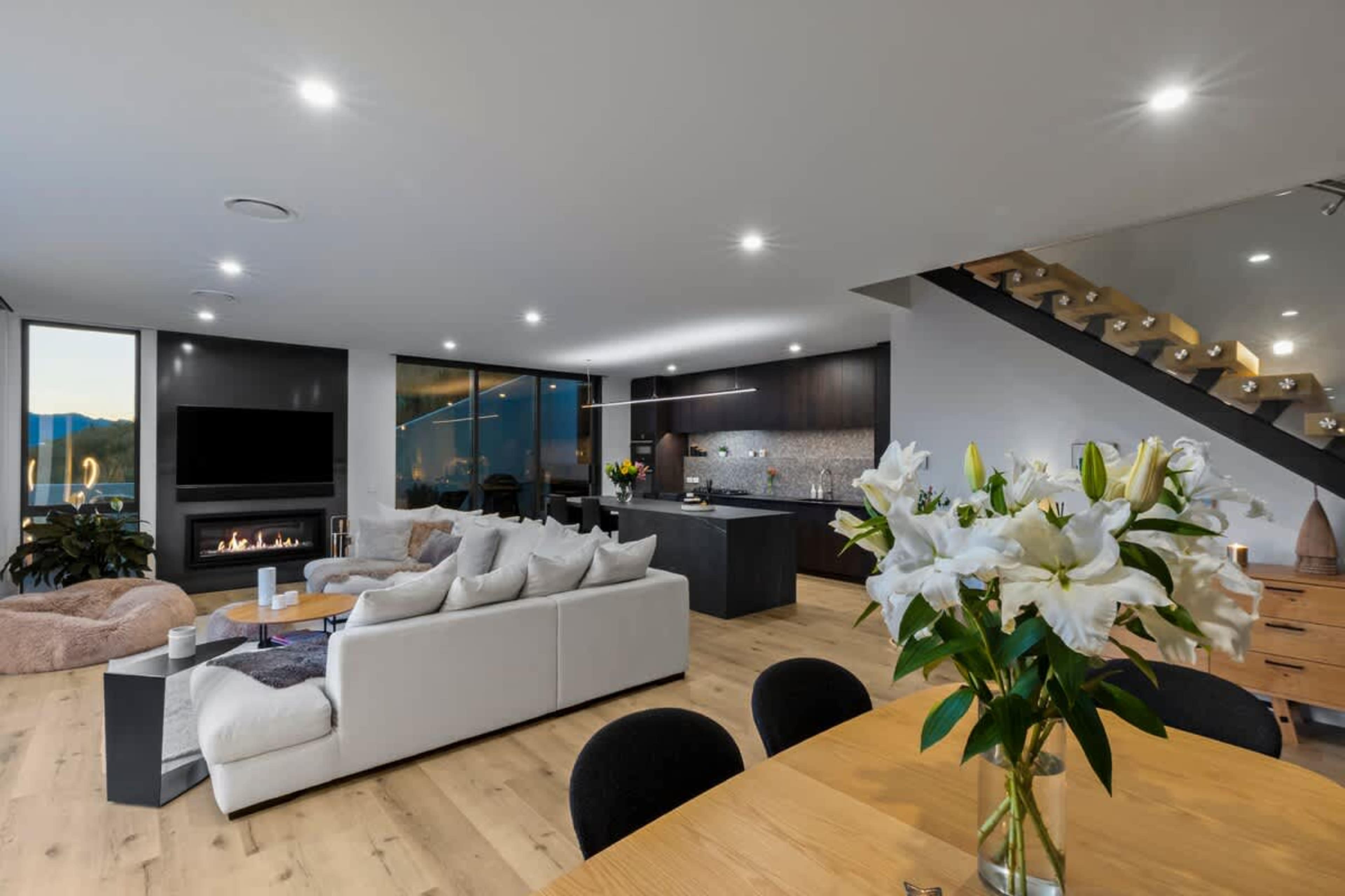 Morning light pours through the windows as you sip coffee and watch the lake shimmer below. This living room was designed to make you pause and take it all in.