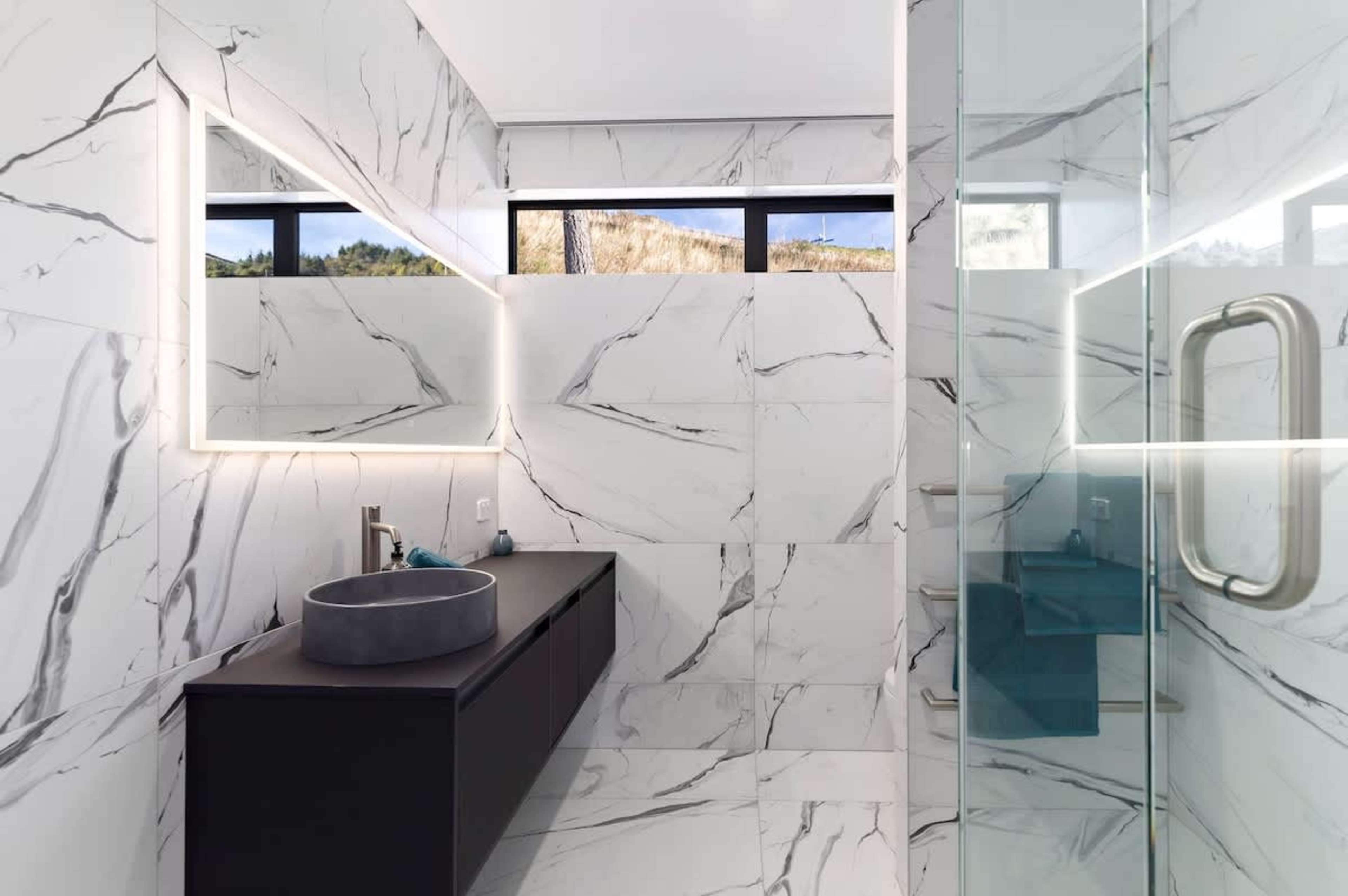 Refresh in the sleek tiled bathroom with a walk-in shower. Perfectly designed for families or groups to share in comfort.