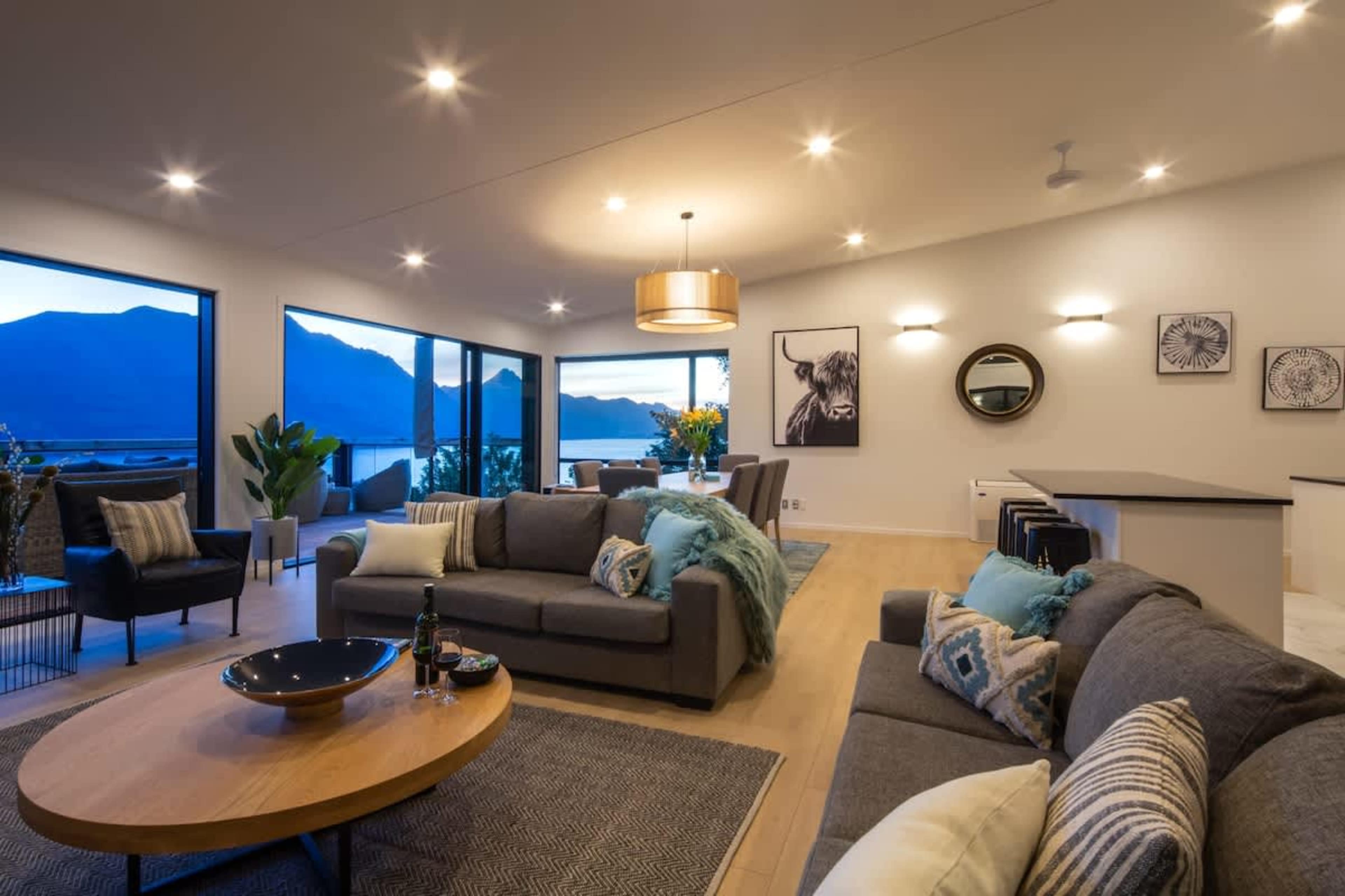 
Elegant Living Space with Views
Unwind in this elegantly designed living room, where modern furnishings and stunning views of the lake and mountains create a perfect atmosphere. It’s the ideal spot to relax, entertain, or enjoy a peaceful evening.