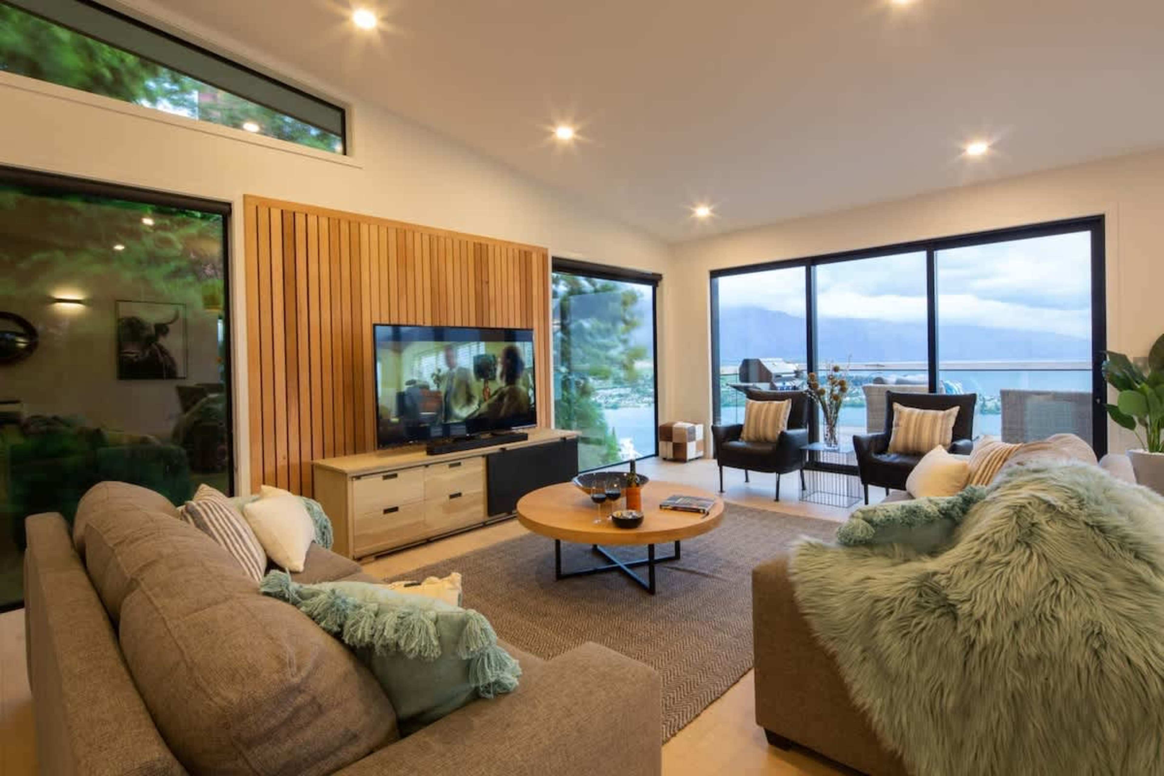 Luxurious Living with Breathtaking Views
The spacious living room features comfortable seating, modern décor, and spectacular lake and mountain views. Whether you’re enjoying quiet moments or hosting guests, this room offers ultimate relaxation