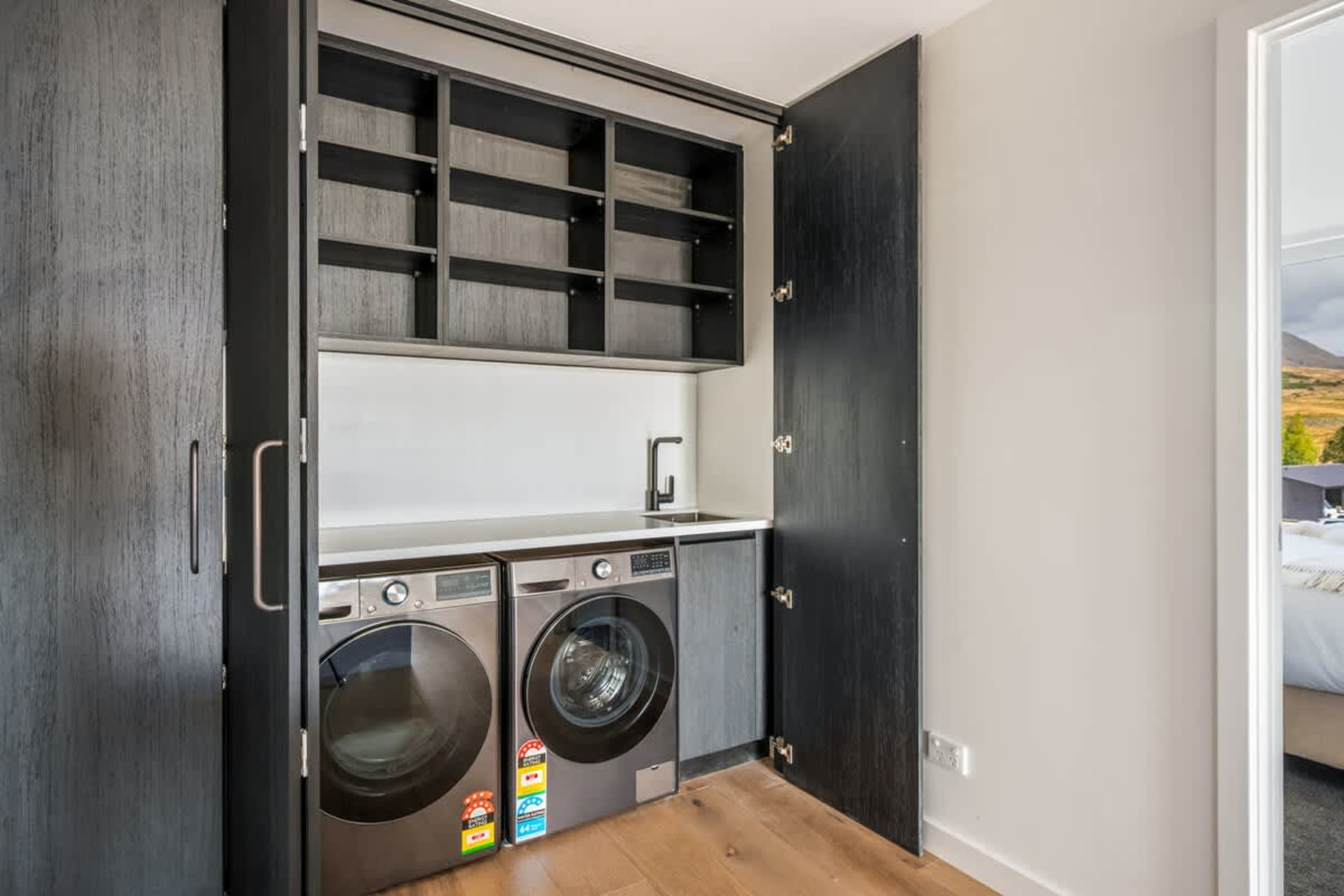 Fully equipped laundry, Clubhouse Lane apartments, Jacks Point Golf Course. Washer, dryer, iron, ironing board, storage, modern alpine design. Convenient for long golf & ski stays in Queenstown.
