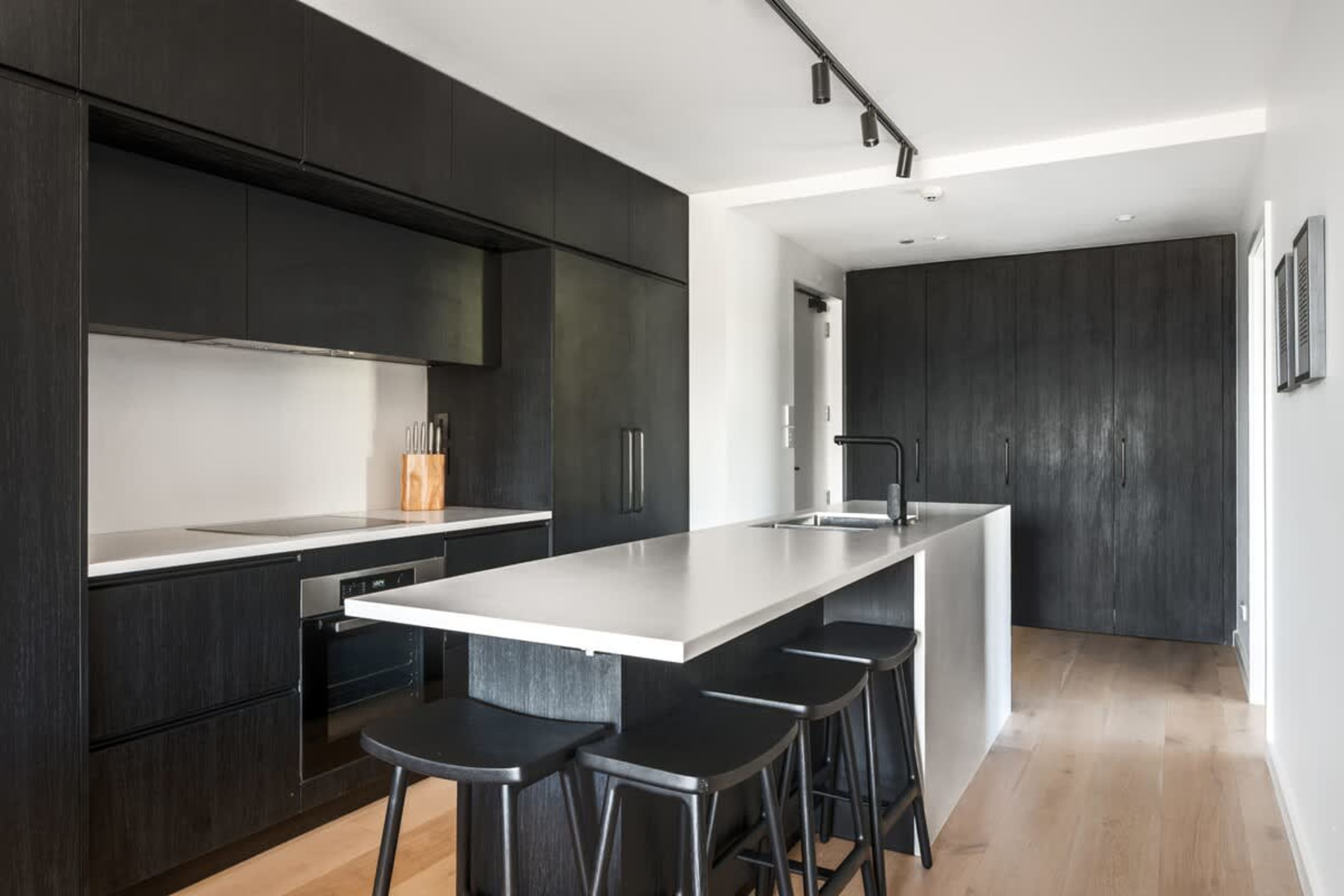 Modern kitchen, Clubhouse apartments Jacks Point. Luxury finishes, stone countertops, top appliances, Nespresso machine with complimentary pods, golf course & Remarkables views. Queenstown luxury stay.