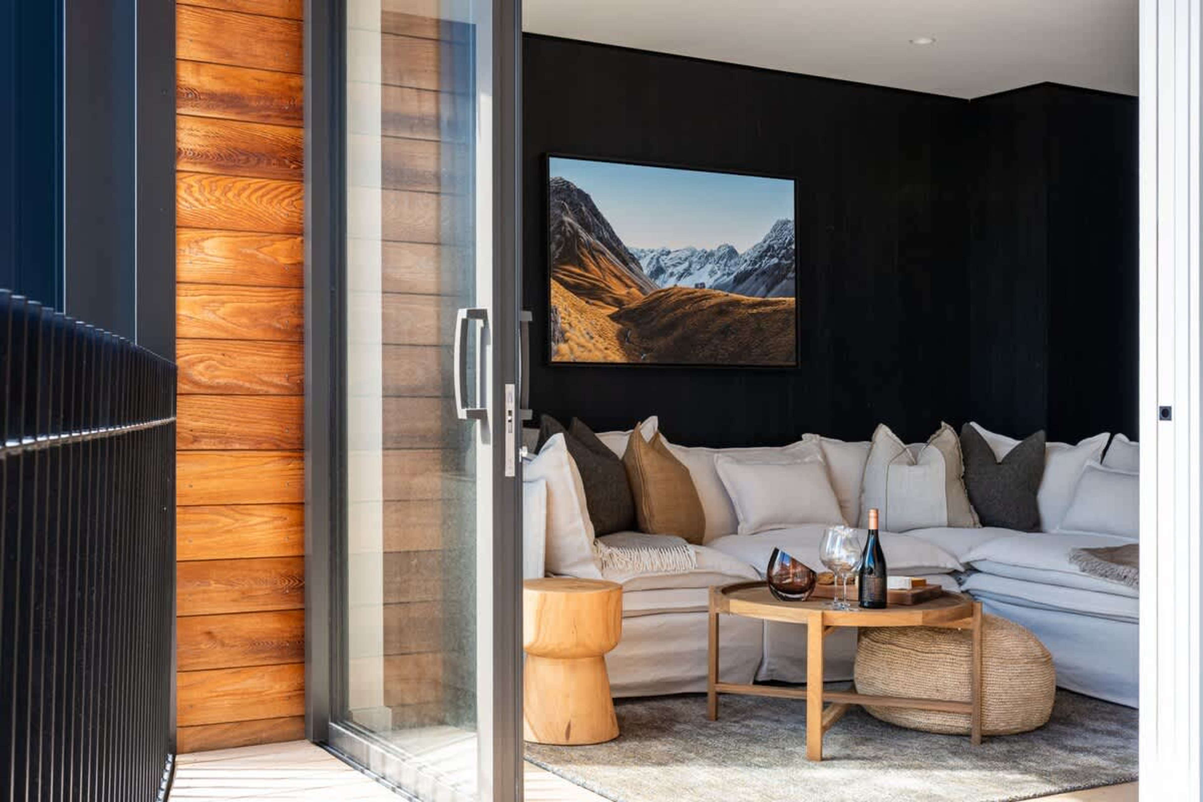 Spacious deck at Clubhouse Lane, Jacks Point. Sweeping panoramic views of The Remarkables & Lake Tewa across the golf course, comfortable outdoor seating, alpine sunset spot. Ultimate Queenstown luxury escape.