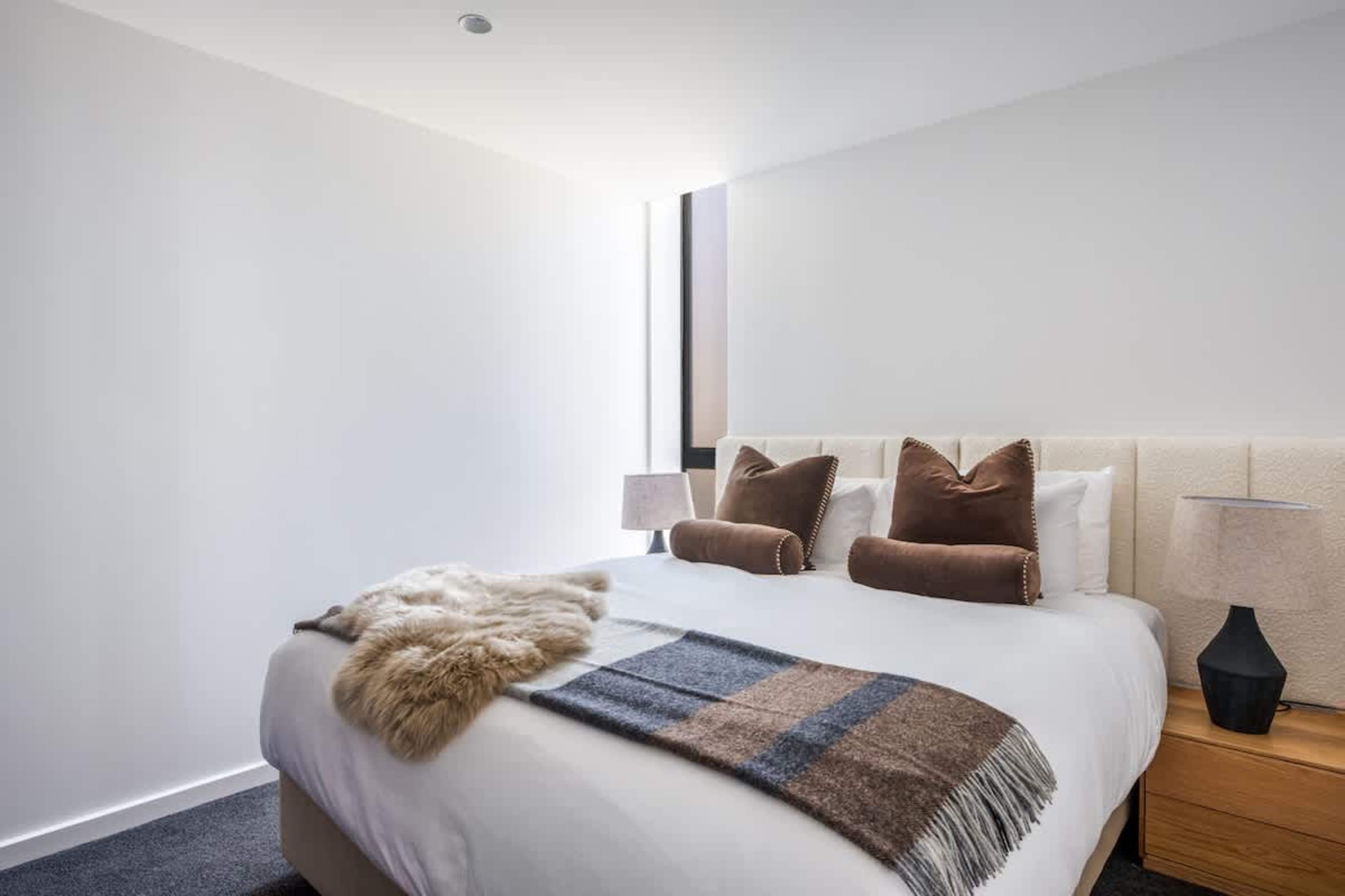 Comfortable second bedroom at Clubhouse Lane, Jacks Point. King-size Sleepyhead bed with ultra-soft premium bedding, cozy modern alpine design, perfect for restful nights. Queenstown luxury escape.