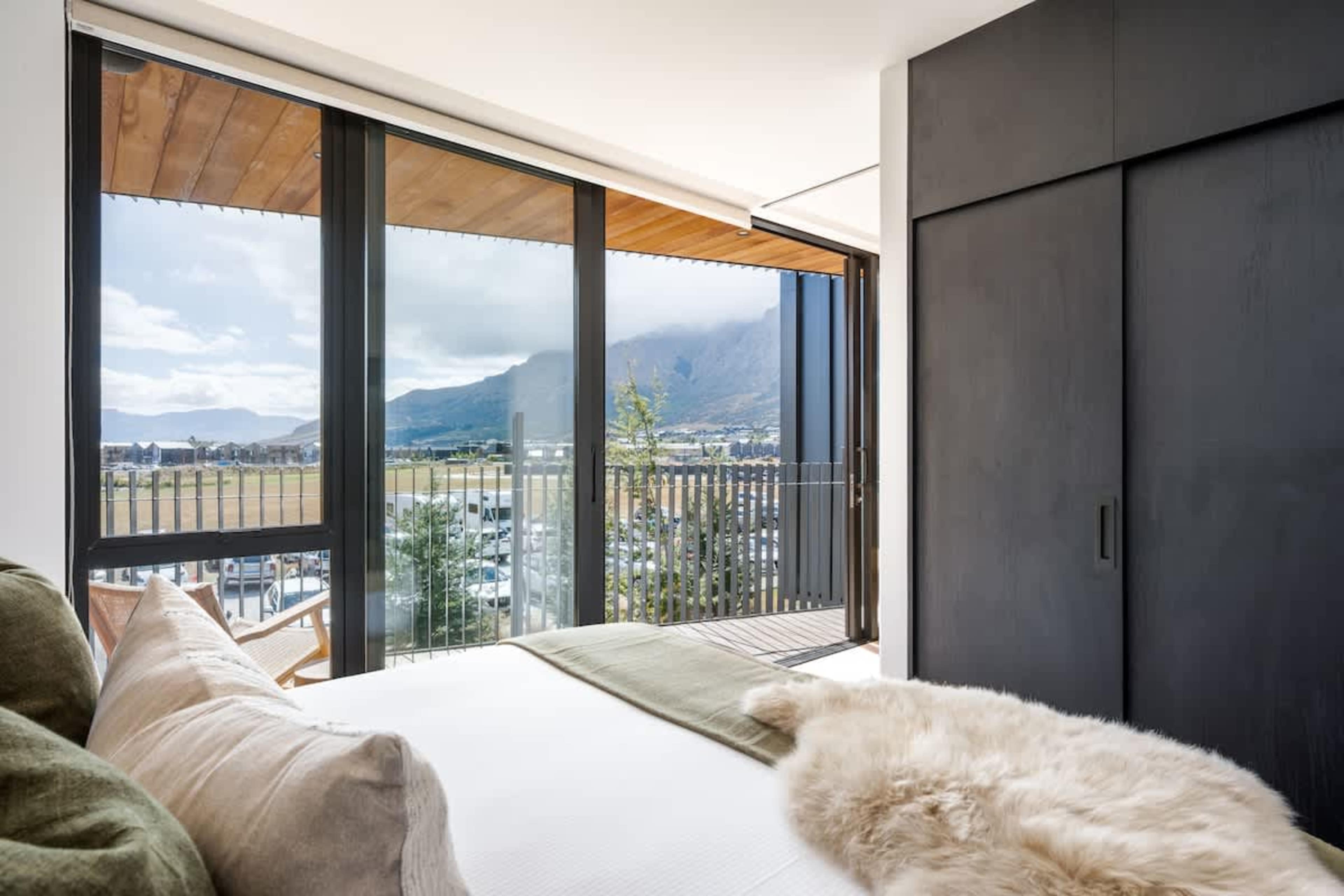 Modern master suite, Clubhouse apartments Jacks Point Golf Course. Brand new Sleepyhead king bed, premium bedding, sweeping Remarkables & Lake Tewa views, stylish alpine interiors. Ideal luxury golf & ski getaway.