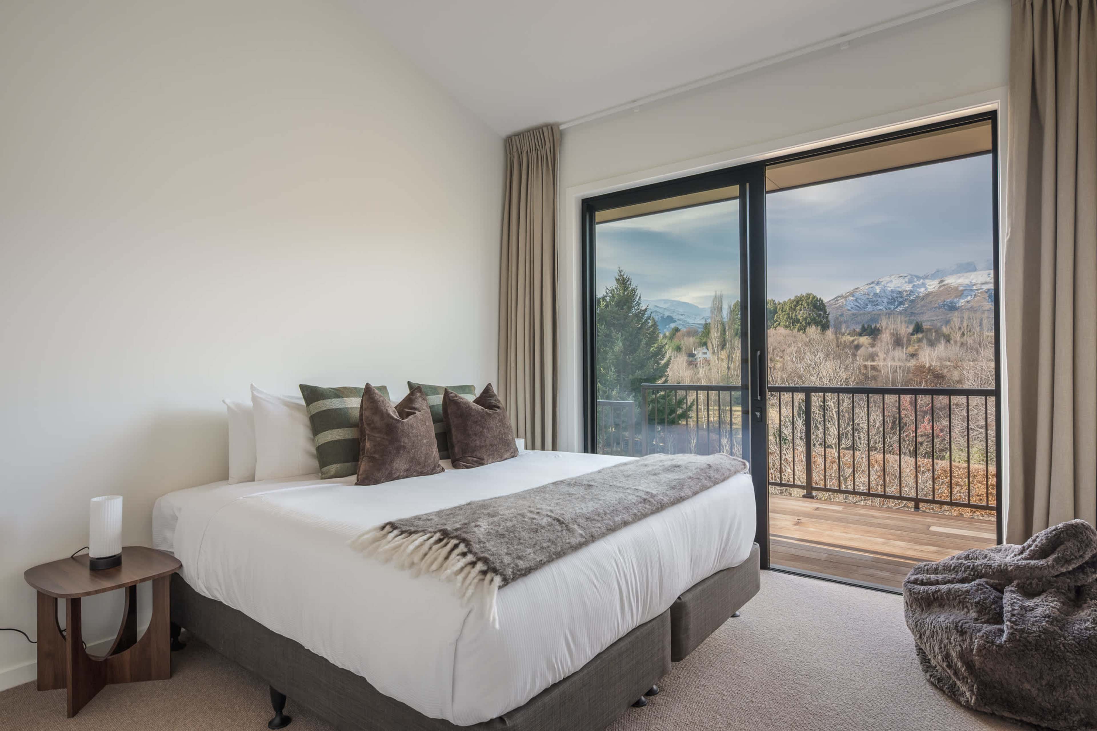 The elegant split king bedroom opens straight onto the sun-drenched deck.