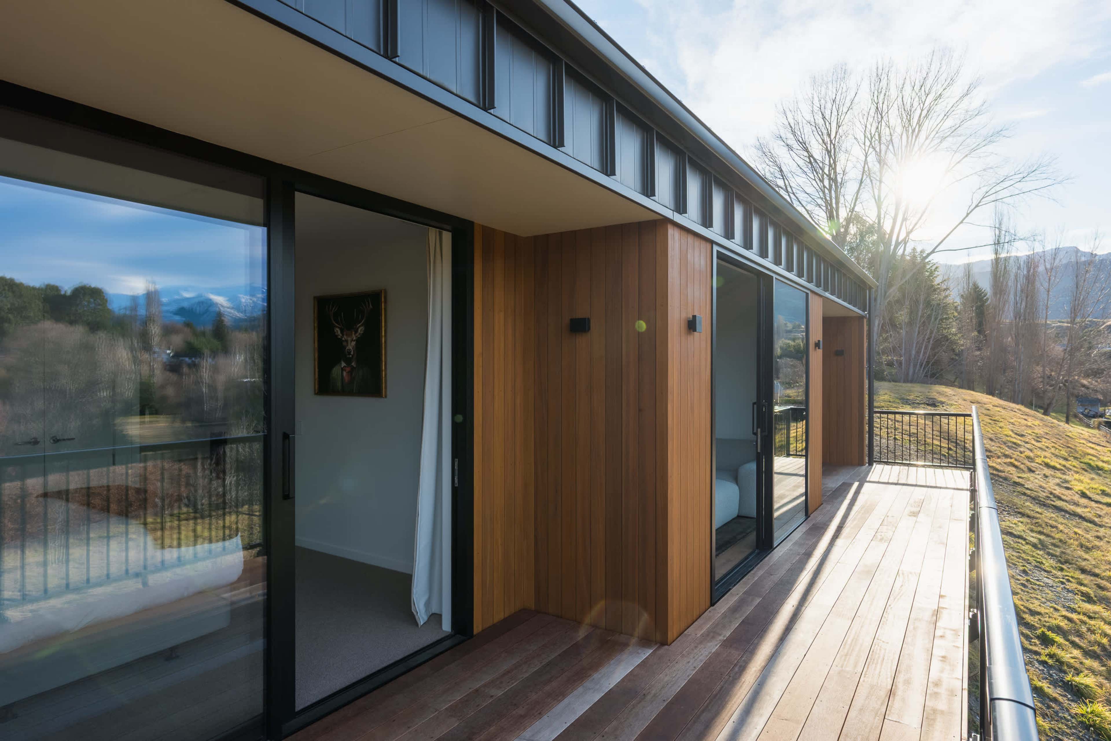The generous deck runs the full length of the house, a private, peaceful perch for slow, sunny mornings.