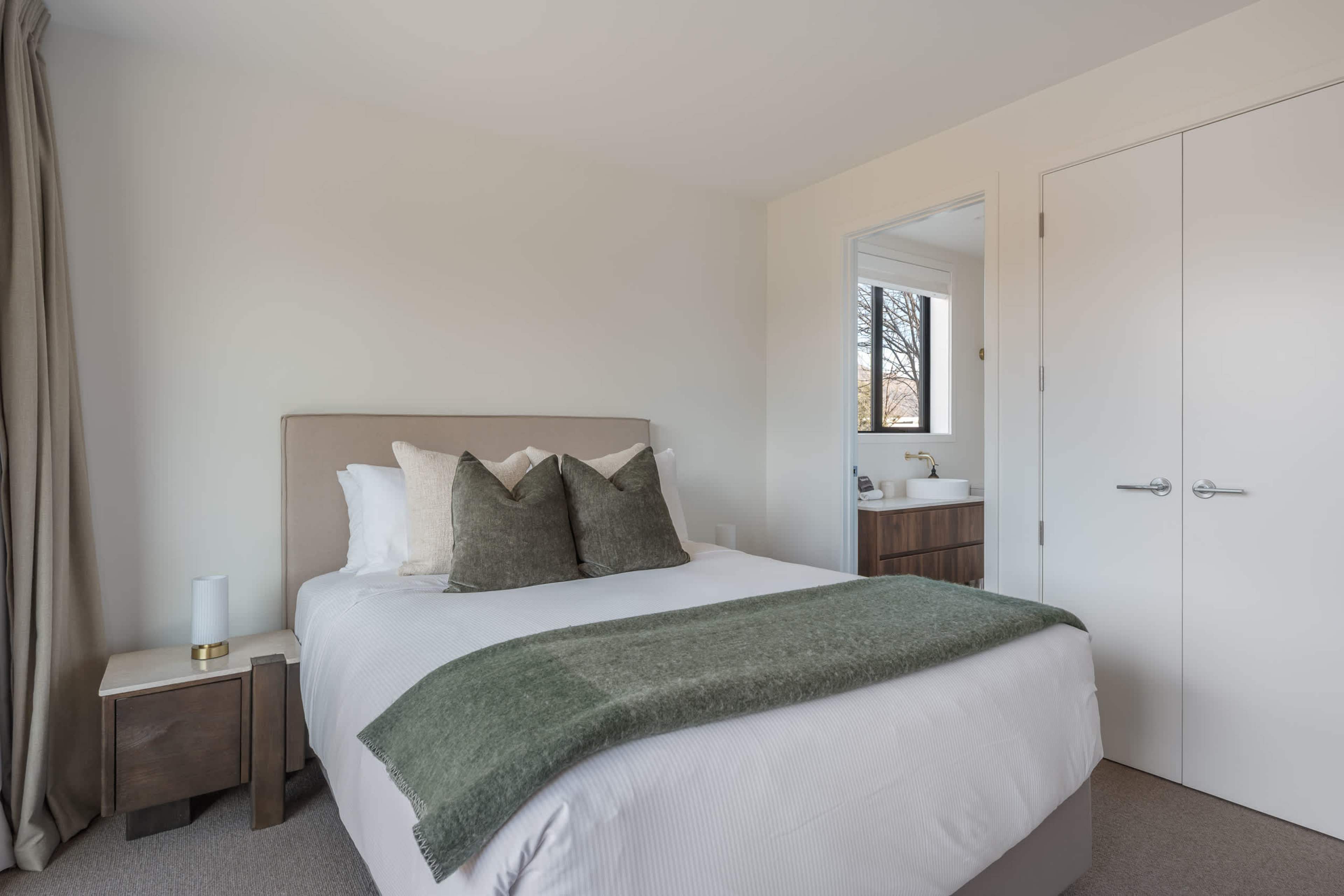 The Queen bedroom is a restful retreat, beautifully dressed in hotel-quality linen, calm and uncluttered.