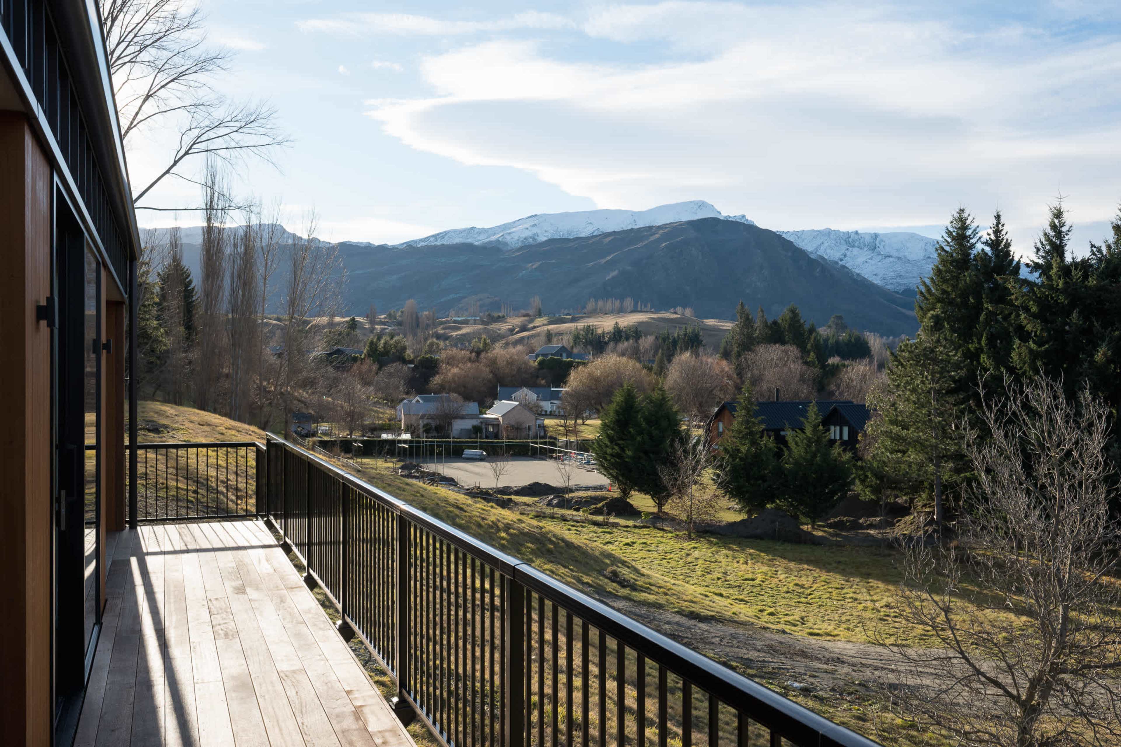 The private deck runs past every bedroom, framed in warm, honey-toned cedar.
