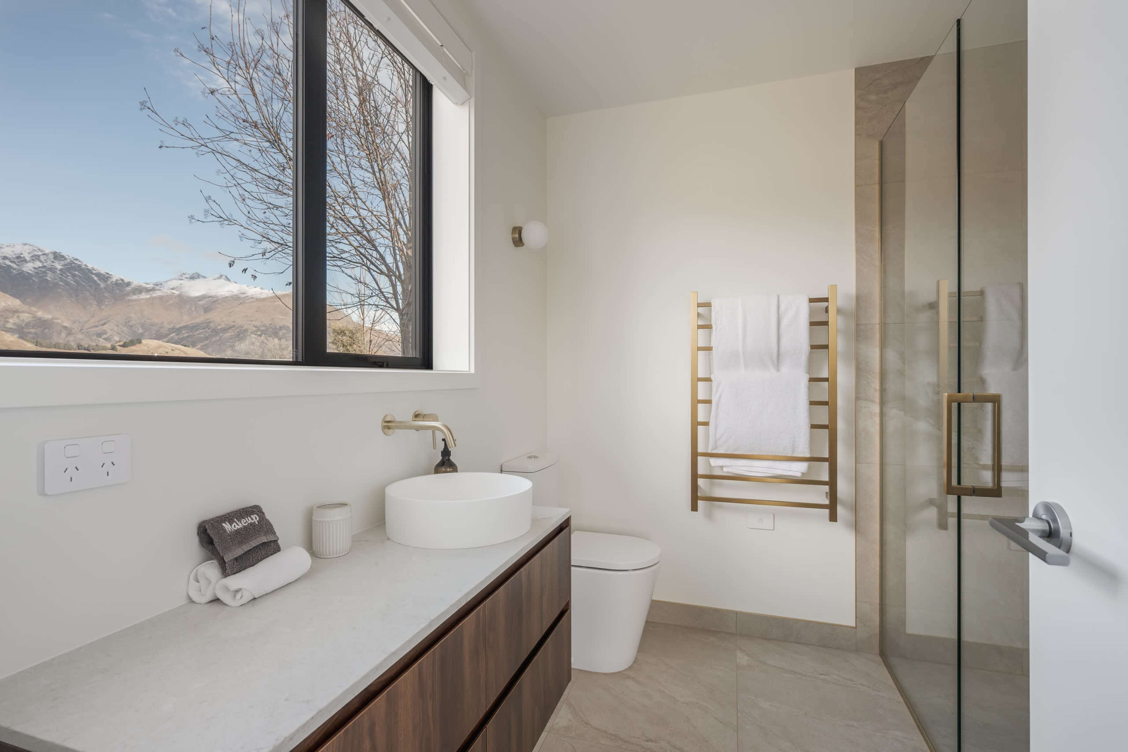 Prep and wash up in style within the ensuite bathroom, with stunning mountain views never out of sight.