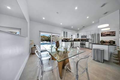 Modern, fully equipped kitchen connected to a stylish dining space
