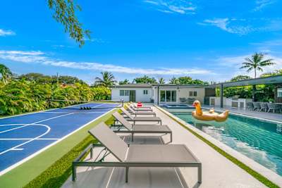 The ultimate backyard with pool, games, and lounge areas