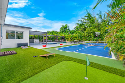 Resort-style backyard with mini golf and a pickleball course.