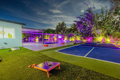 Nighttime backyard entertainment with dining, BBQ, and games