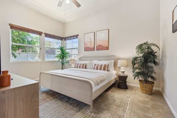 Wake up refreshed in this serene bedroom with plenty of natural light.