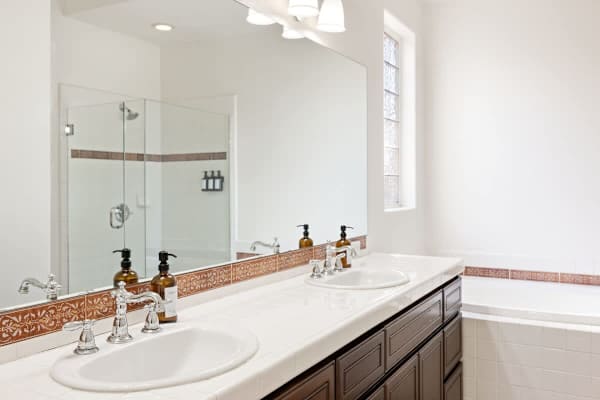 Master-suite bathroom with dual sinks and elegant finishes for pampering yourself daily.