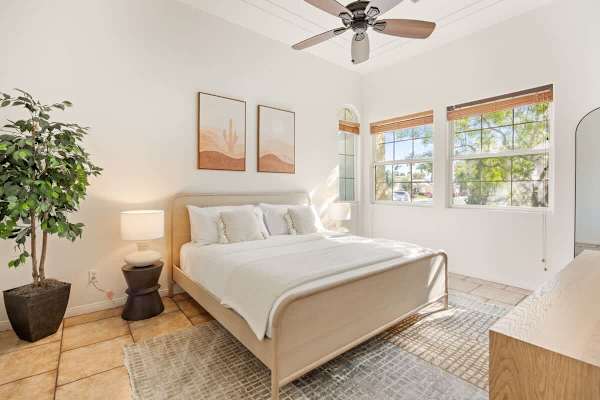 Soft bedding and natural light create the perfect start to each new day.