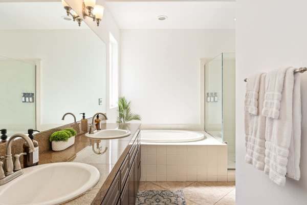 Clean bathroom lines with bathtub and walk-in shower offer luxurious choices daily.