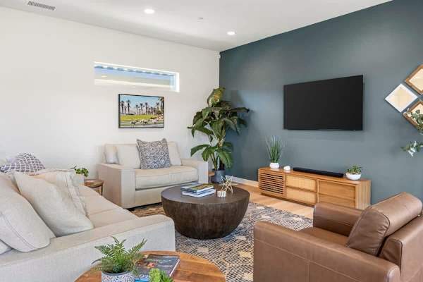 Teal statement wall anchors this bright retreat.