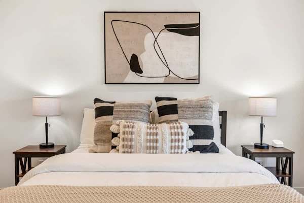 Abstract line art above textured bedding—casita bedroom brings style and comfort together.