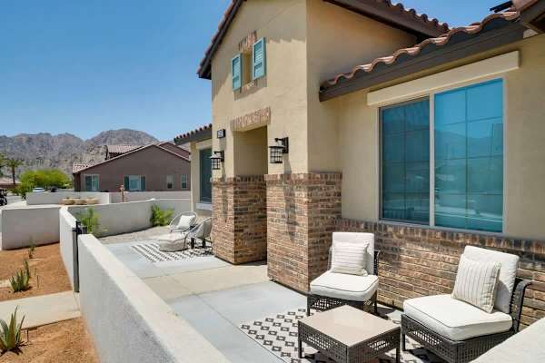 Stone and stucco welcome you home—private seating invites morning coffee moments outside.