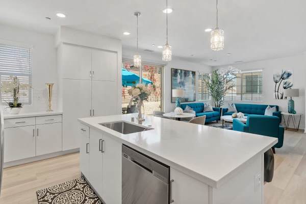 White cabinets and counters with views straight through to the living room.