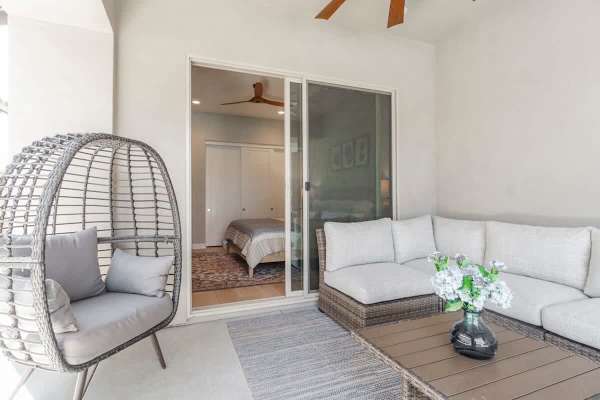 Egg chair and covered seating overlook the pool—shade and style.