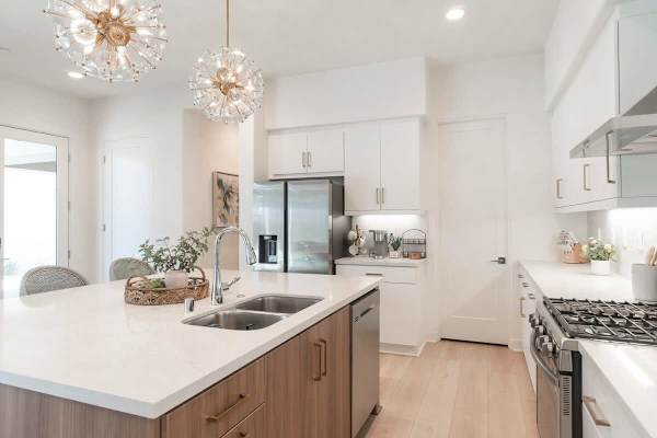 This kitchen features an abundance of lighting and bar-height dining,