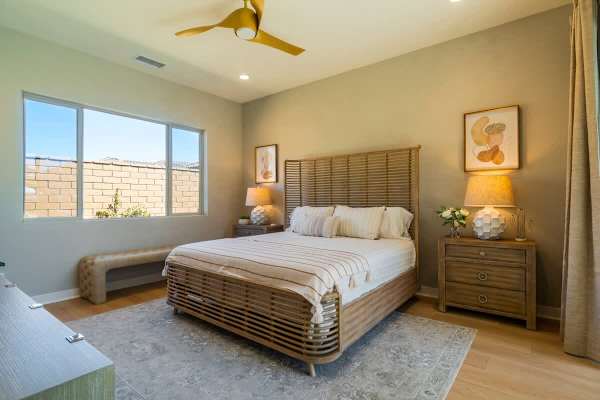 Primary bedroom with golf course art and warm wood tones.