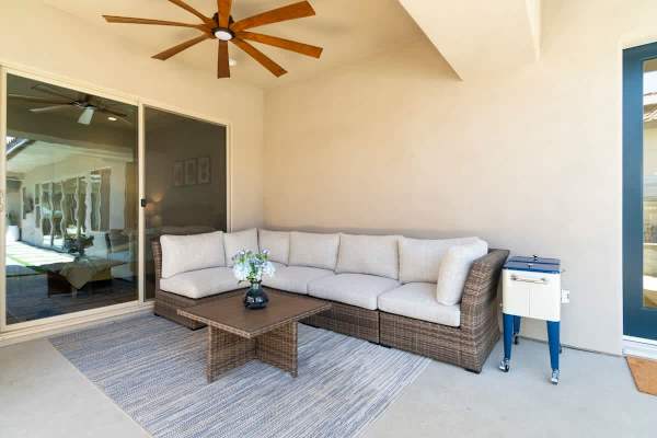 Large sectional under ceiling fan—dine alfresco or lounge poolside.
