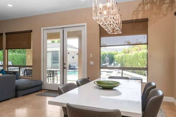 Sliding glass connects indoor meals to outdoor entertaining seamlessly.