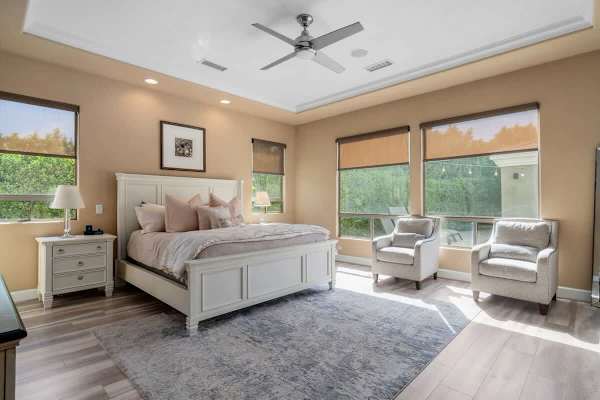 Primary bedroom with garden views and sitting area.